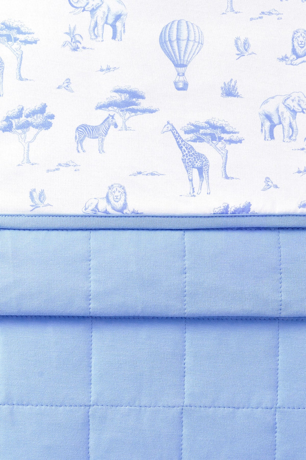 Close up of the Toddler Blanket in Toile Safari 1.0 showing the quilted blue backing and smooth printed top layer