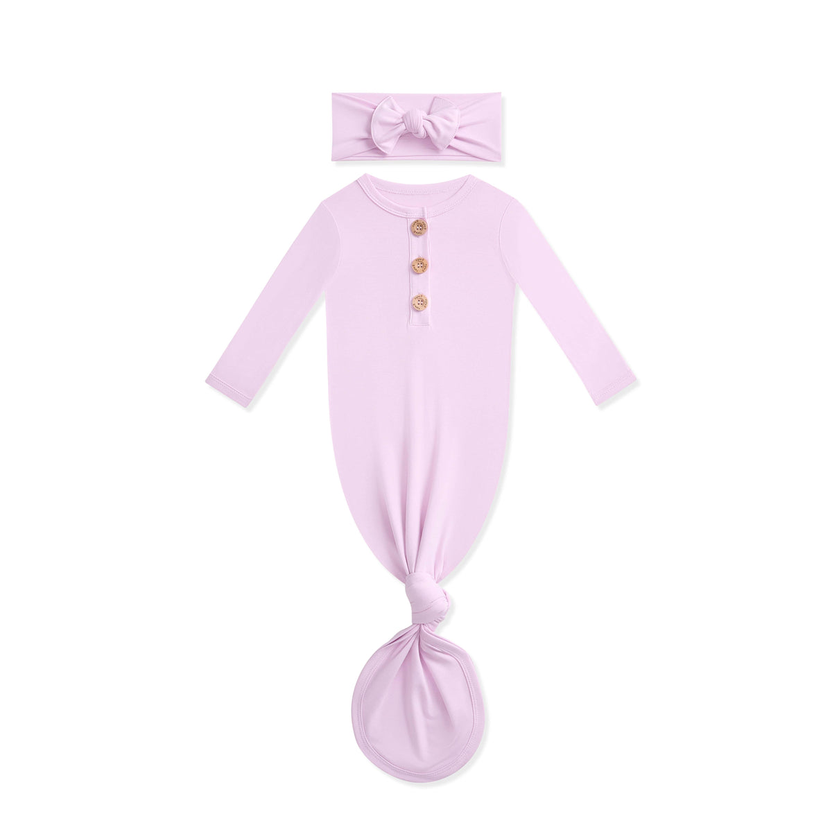 Lavender baby knotted gown with wooden buttons and matching headband on a white background