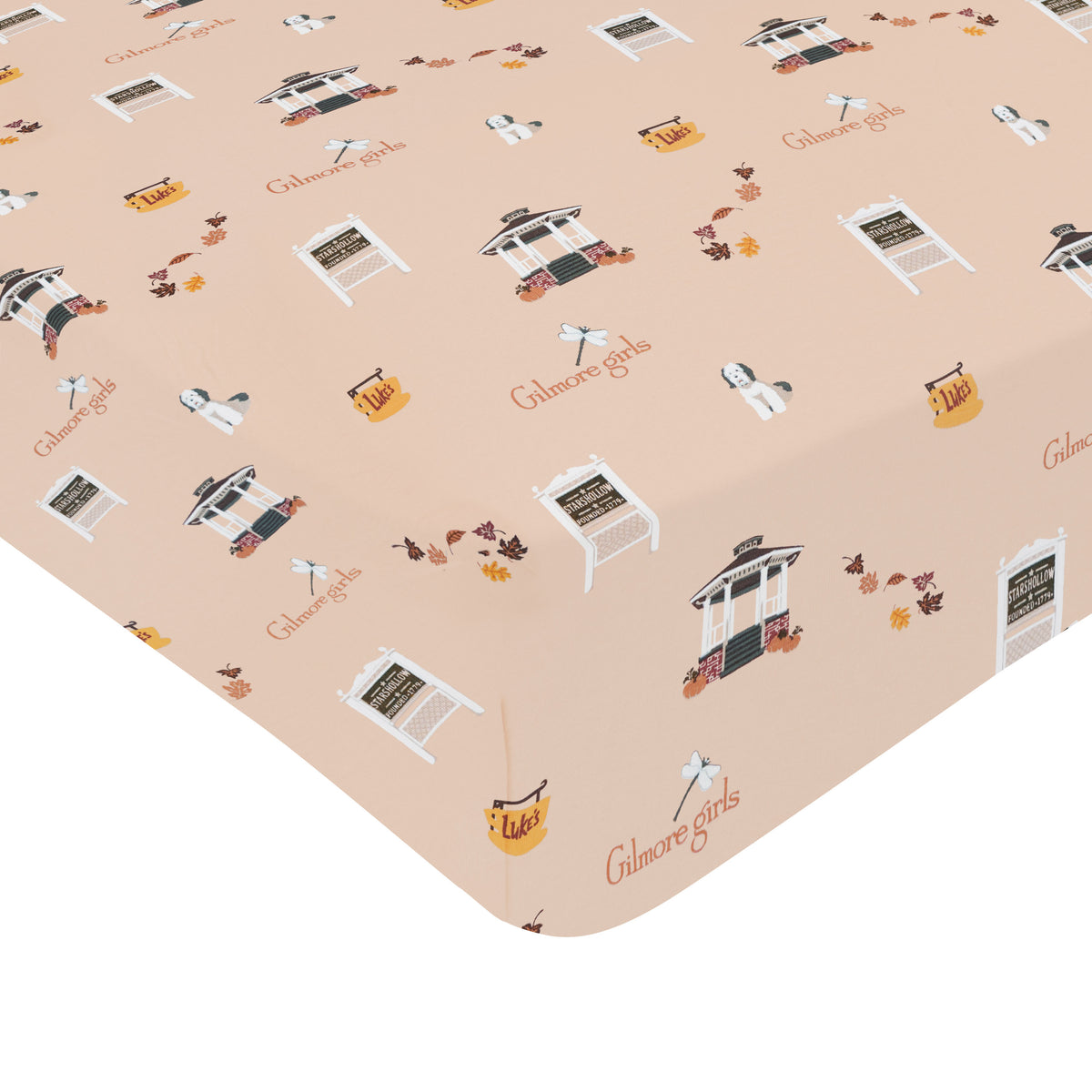 Fitted sheet with 'Gilmore Girls' theme featuring icons and text on a beige background