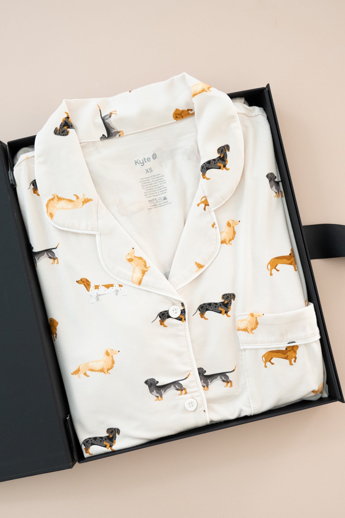 Women's Short Sleeve Pajama Set in Dachshund print packed in a box on a beige background