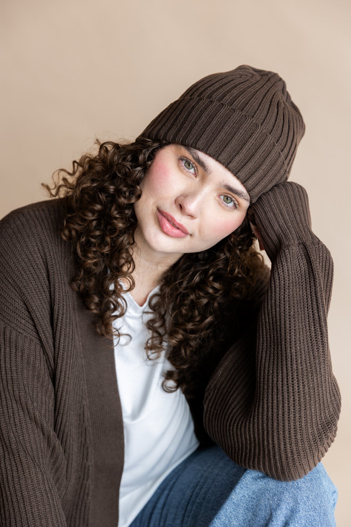 Modal wearing chunky knit adult ribbed beanie in espresso with chunky knit cardigan in espresso