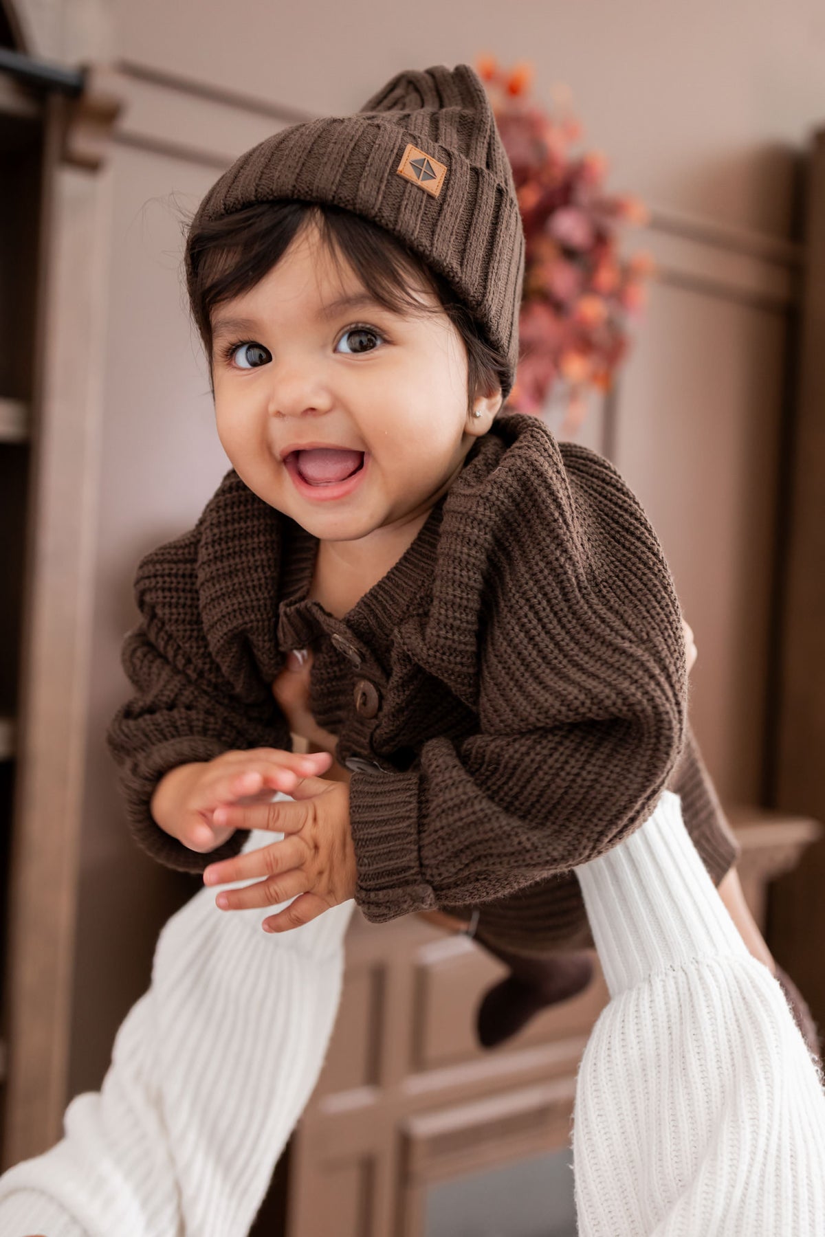 Baby wearing wearing Chunky knit romper under Chunky knit ribbed beanie in Espresso