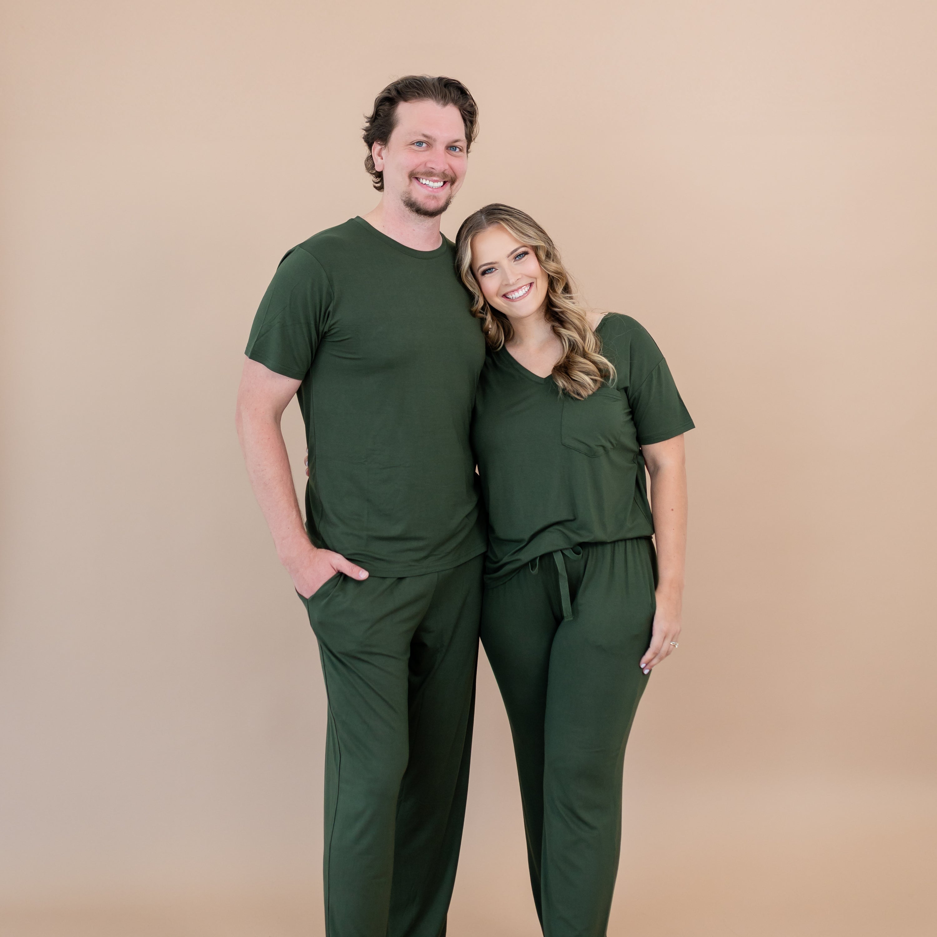 Couple in matching loungewear in a dark green color called Fir