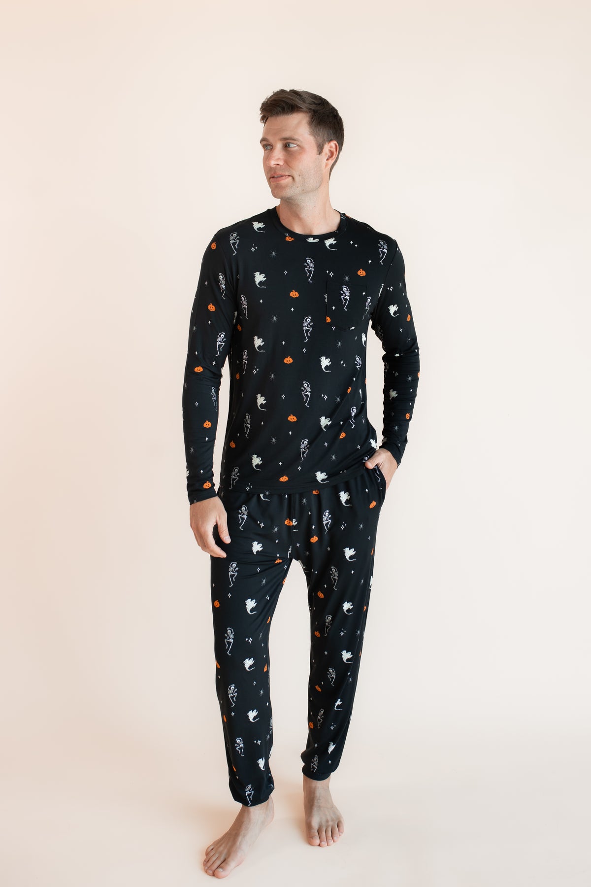 Modal wearing Men's Jogger Set in Halloween Friends print on beige background