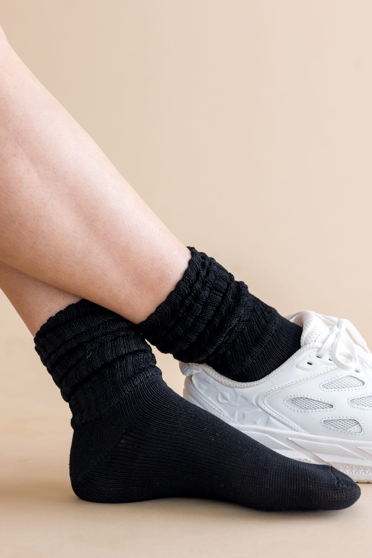 Adult Scrunch Socks in Midnight shown on a models feet with a white sneaker on one foot