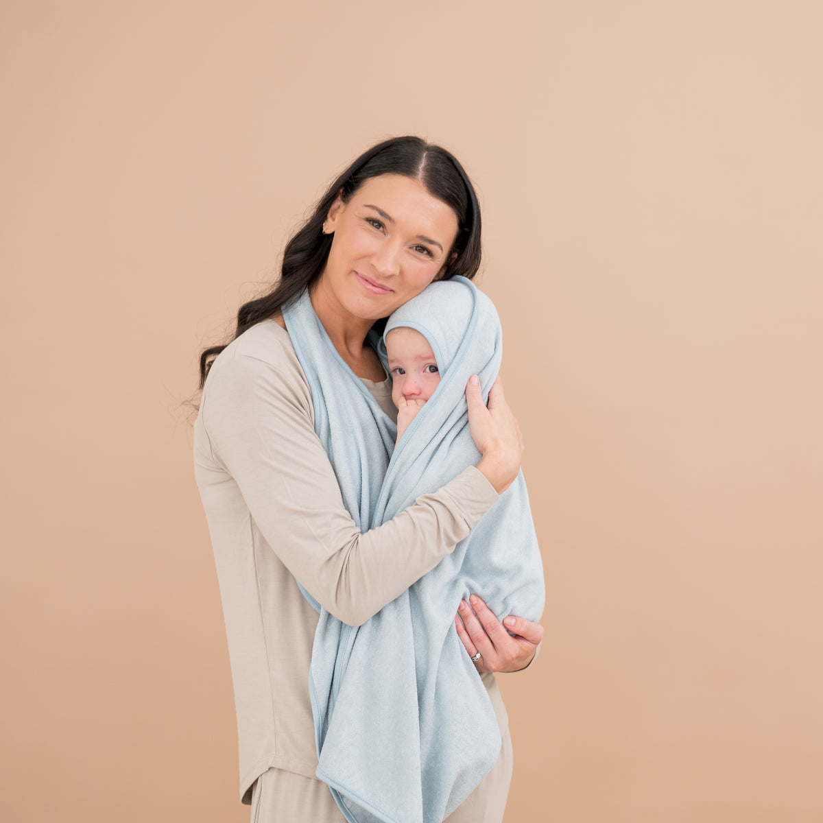 Mom holding baby wrapped in Bamboo Terry Apron Towel in Fog