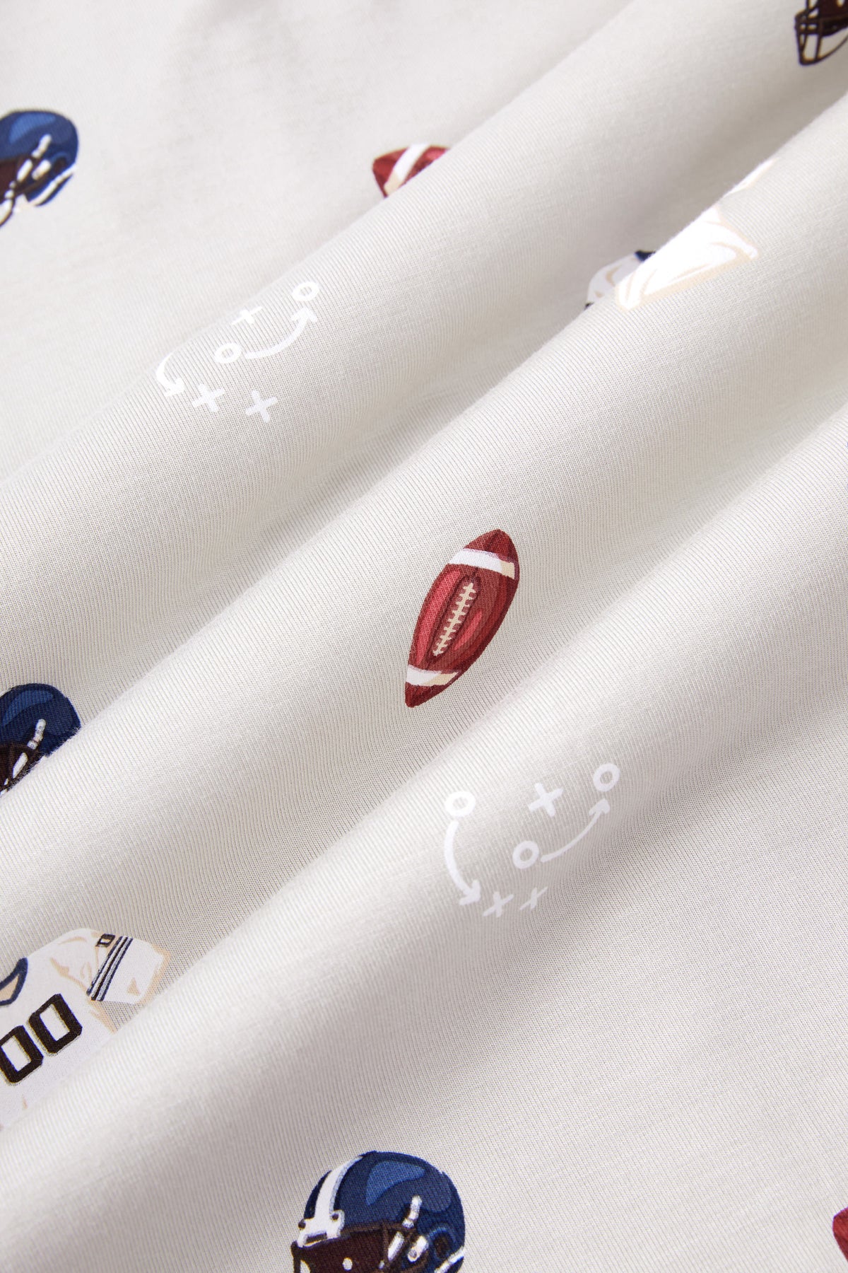 Close up of Vintage Football print on an Oat color fabric