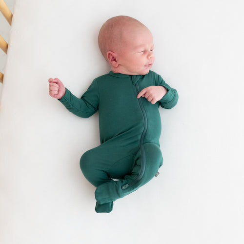 Newborn in Kyte Baby footie pajamas