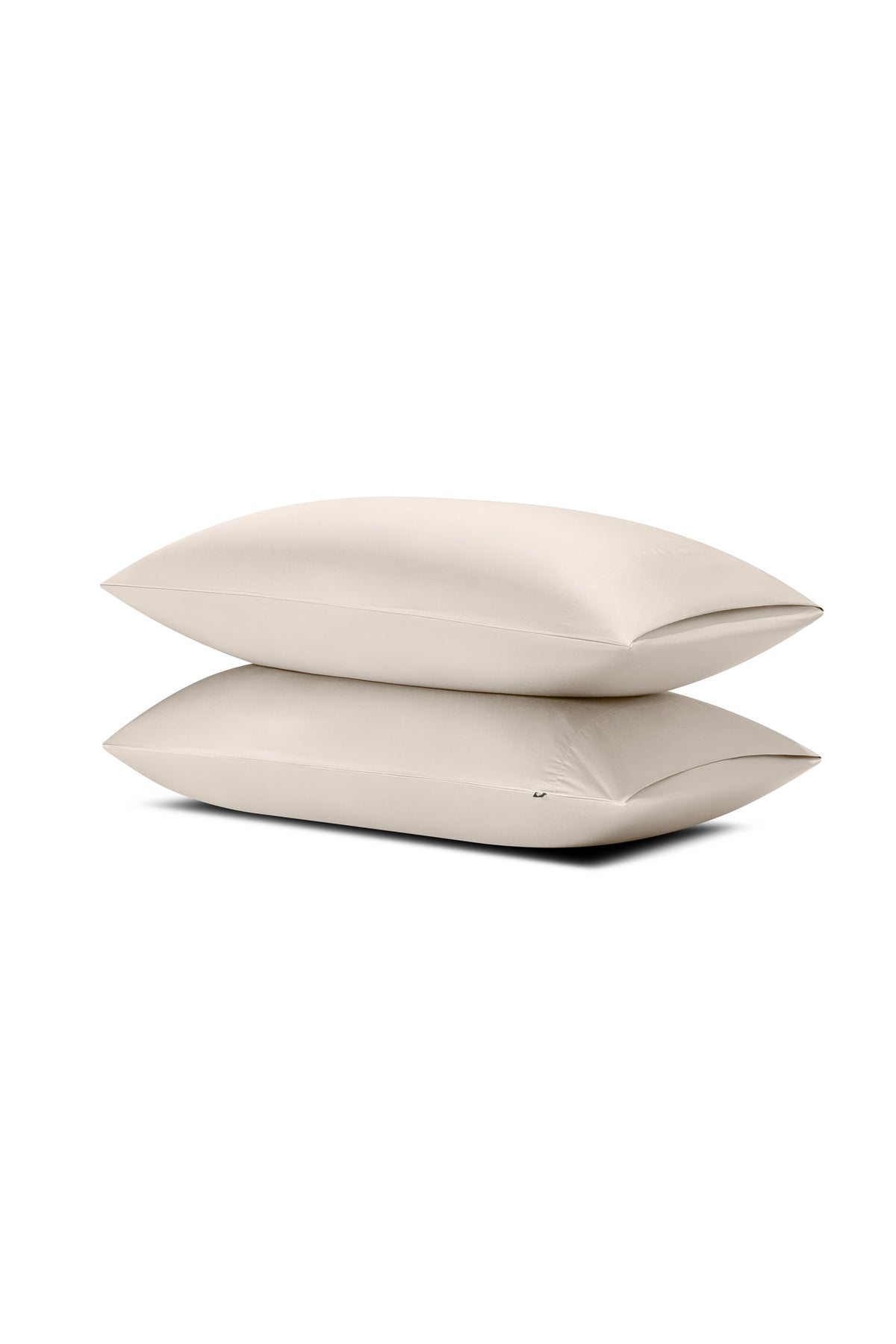 Two pillows stacked one on top of the other with the Bamboo Sateen Pillowcases in Sand Stone on them