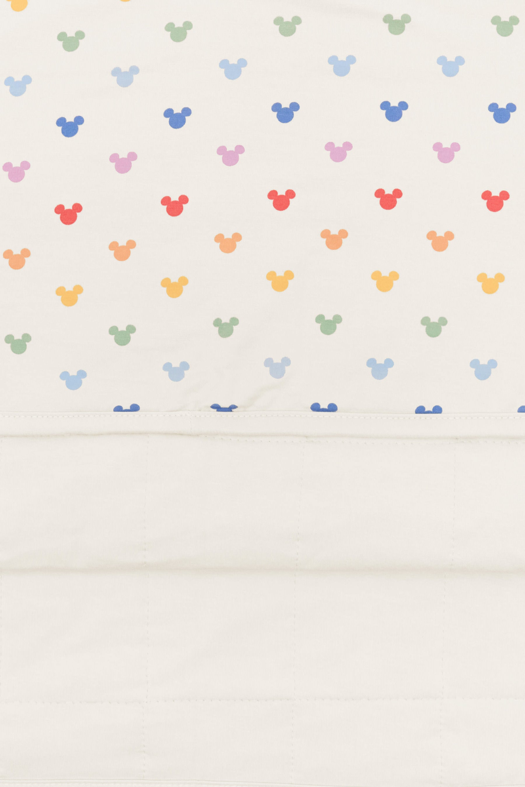 Back side fabric of baby blanket with pastel mickey mouse icons on an oat background