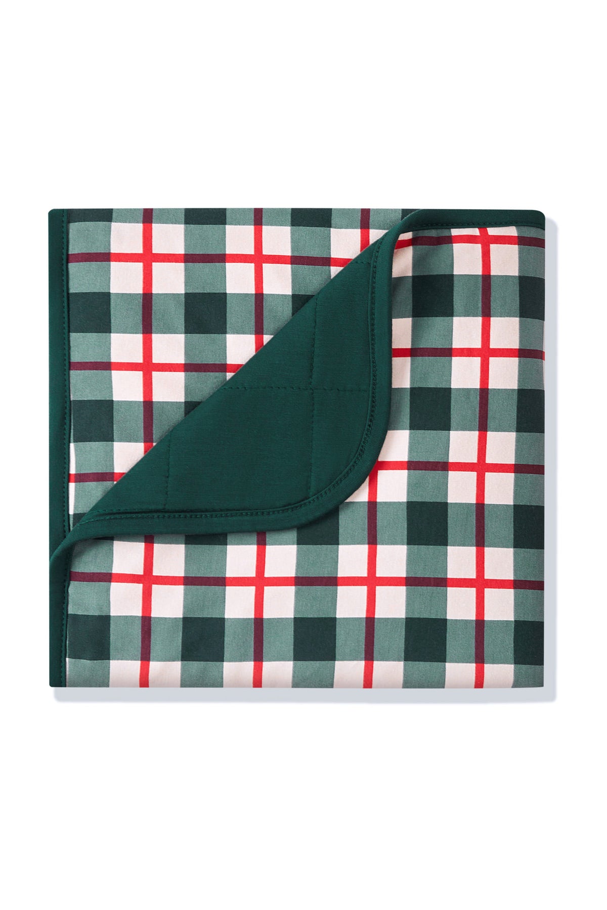 A folded blanket with a green, white, and red plaid pattern, showing a solid dark green reverse side, photographed on a clean white background.