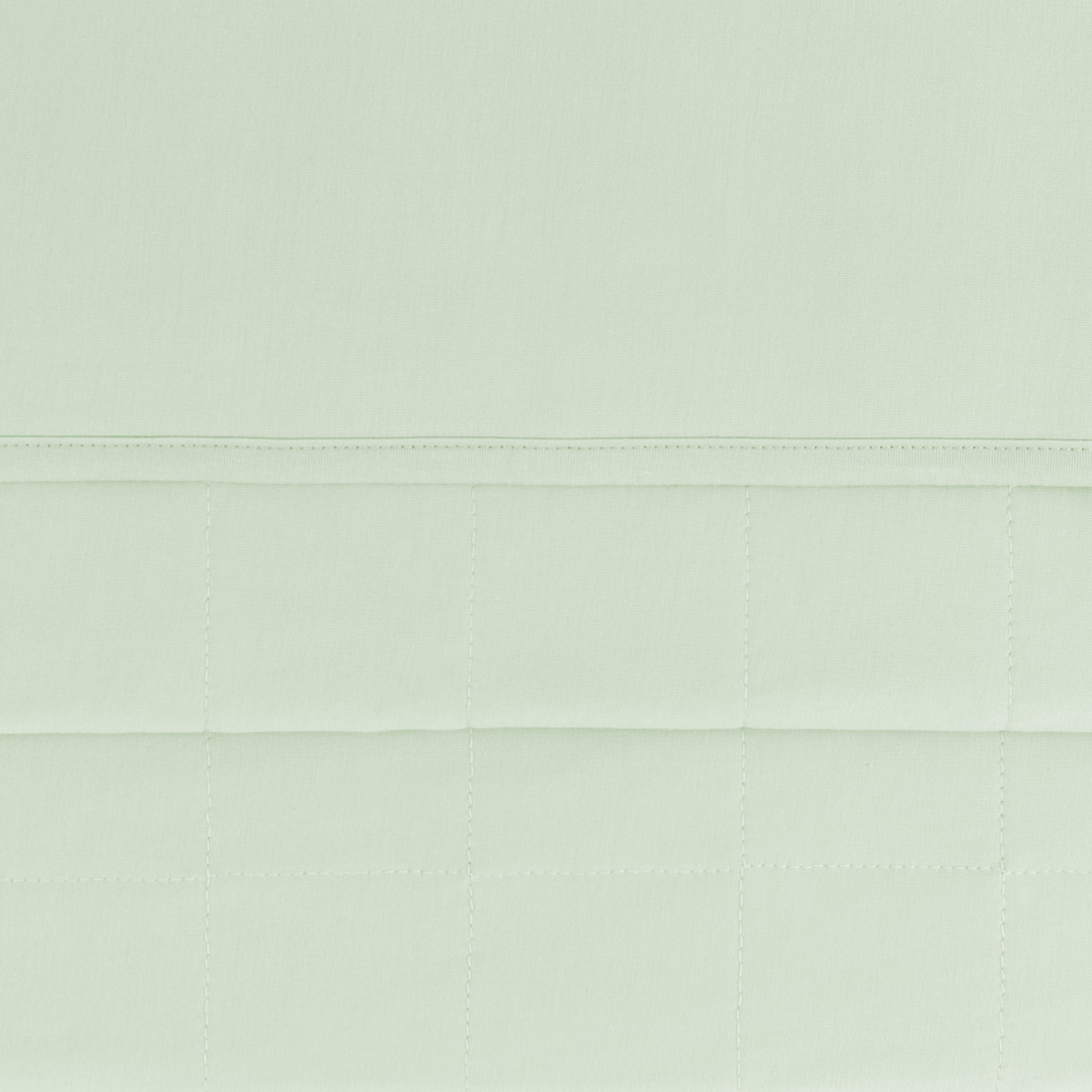 Close up of the quilted bottom and smooth top layer on the Baby Blanket in Basil 1.0