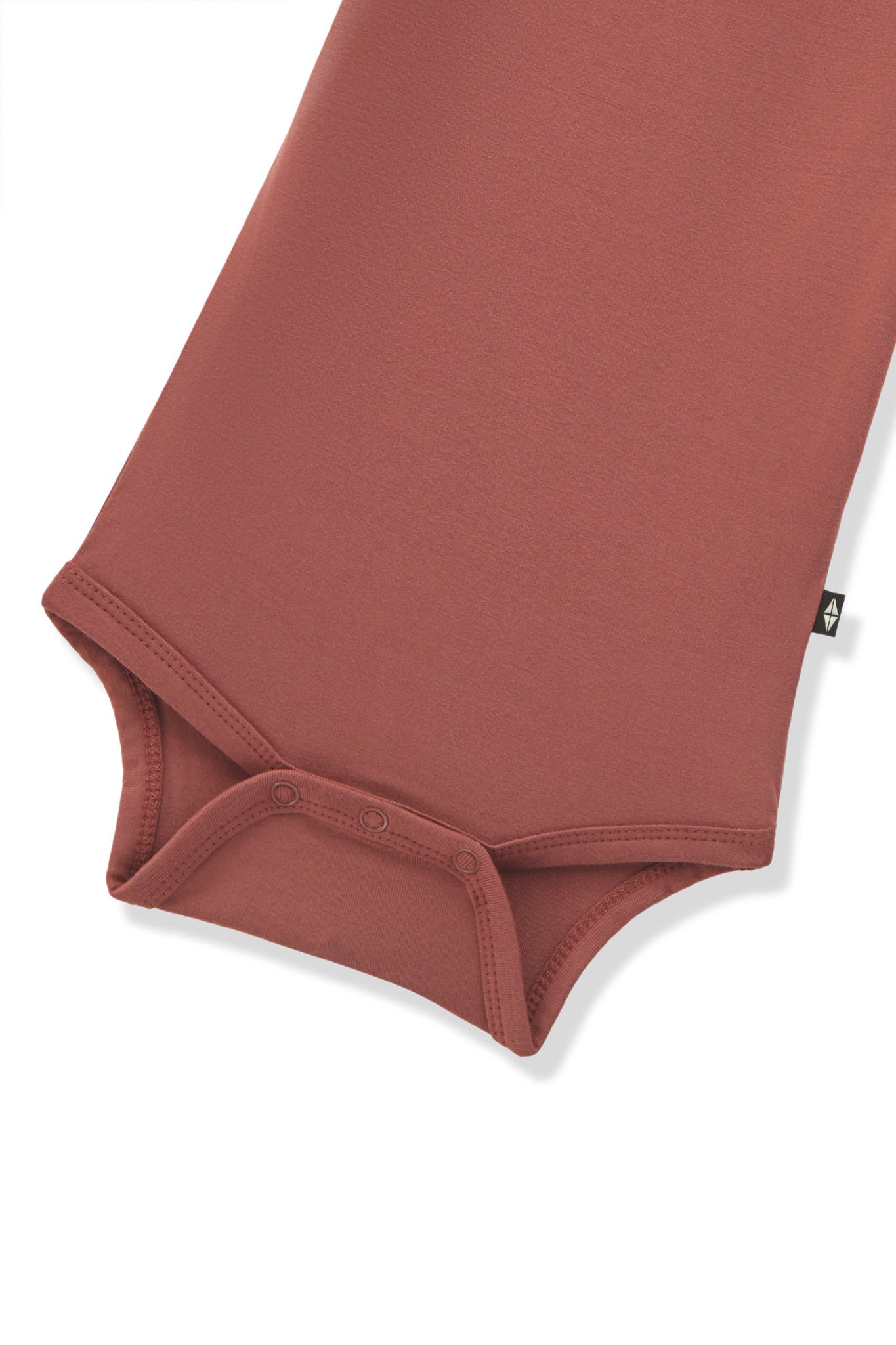 Bottom part of Long Sleeve Bodysuit in Ember with snap buttons on a white background