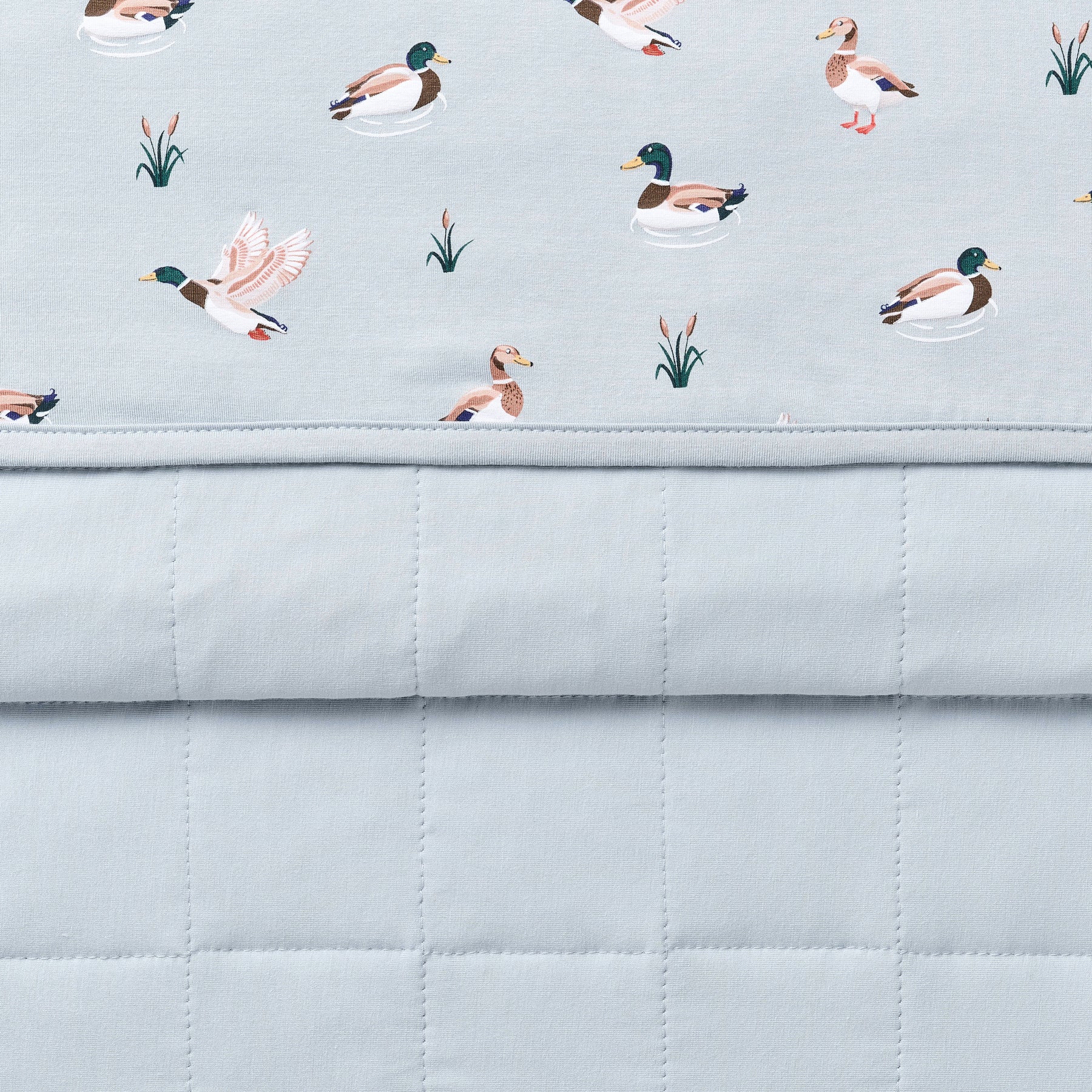 Close up of the Toddler Blanket in Mallard Duck 1.0 showing the light blue quilted backing and patterned smooth to player