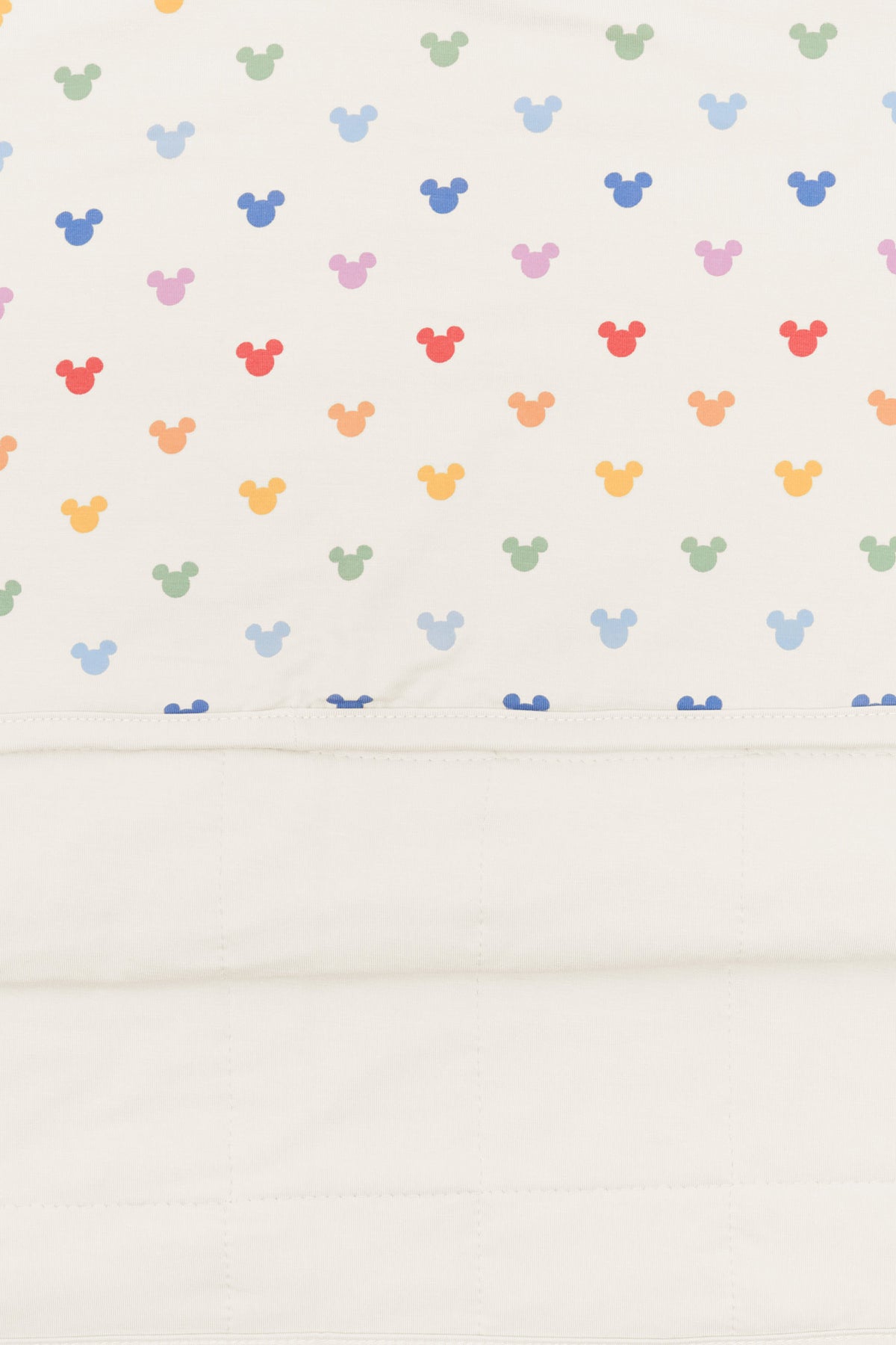 Back side fabric of Toddler Blanket in Pastel Mickey Mouse pattern on an oat background