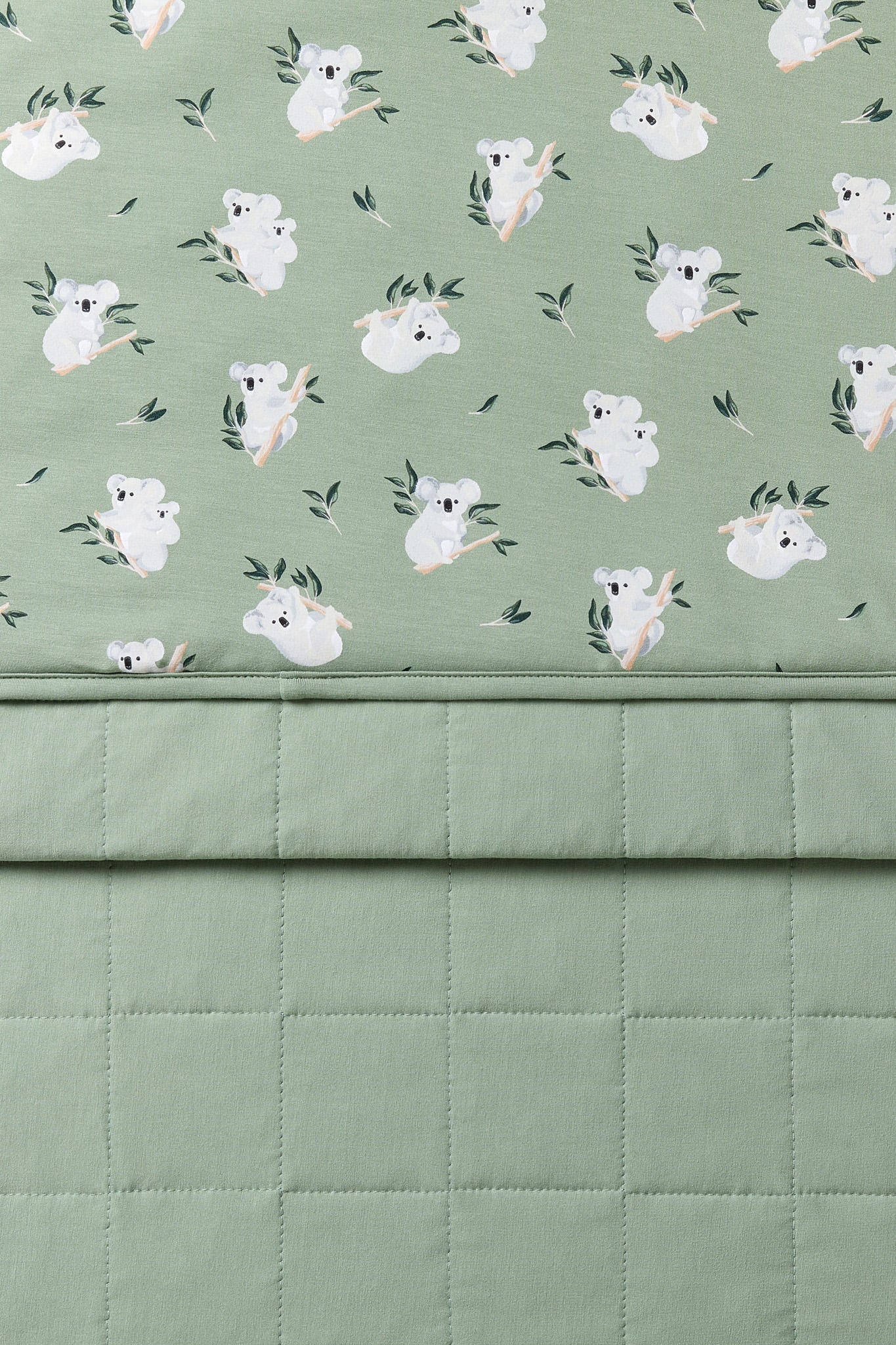 Close up of the Baby Blanket in Koala showing the quilted backing and smooth printed top layer