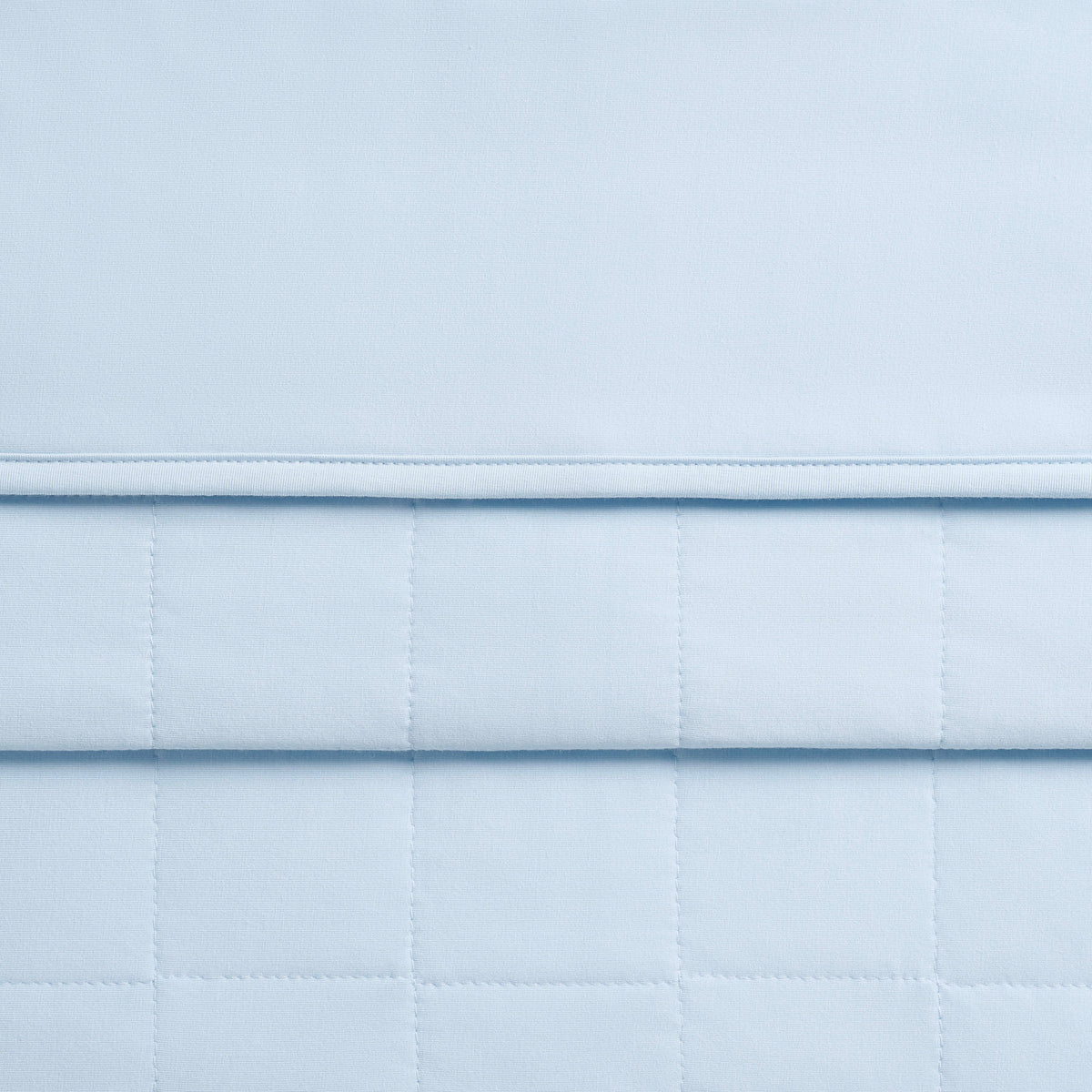 Close up of the Toddler Blanket in Breeze 1.0 showing the quilted backing and smooth fabric top