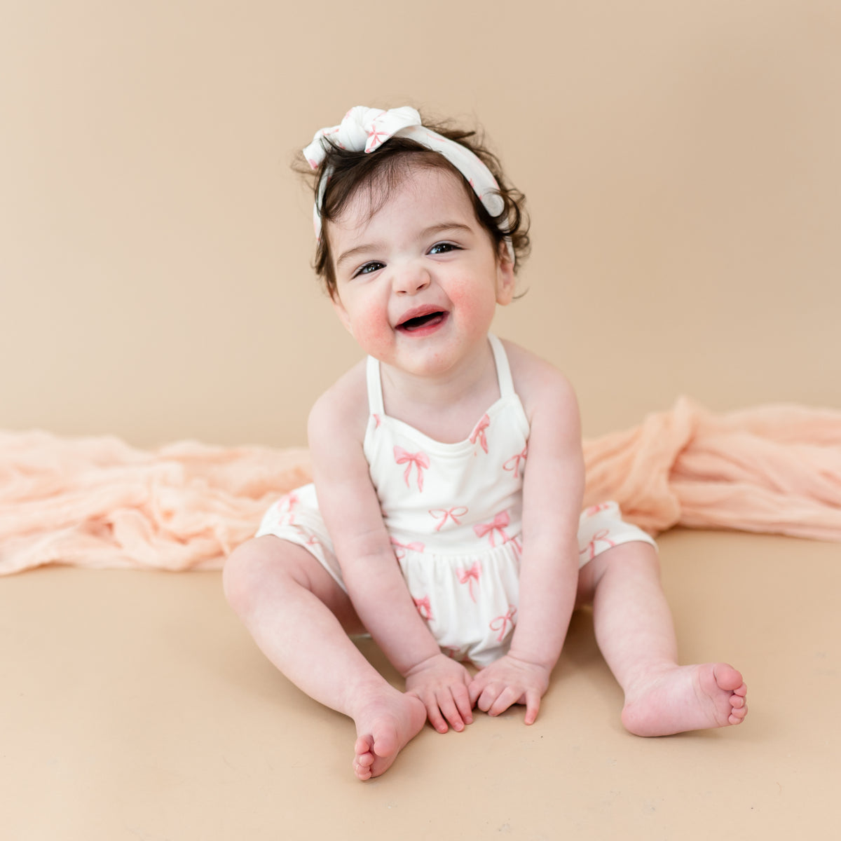 Young toddler wearing Spaghetti Strap Ruffle Romper in Bow