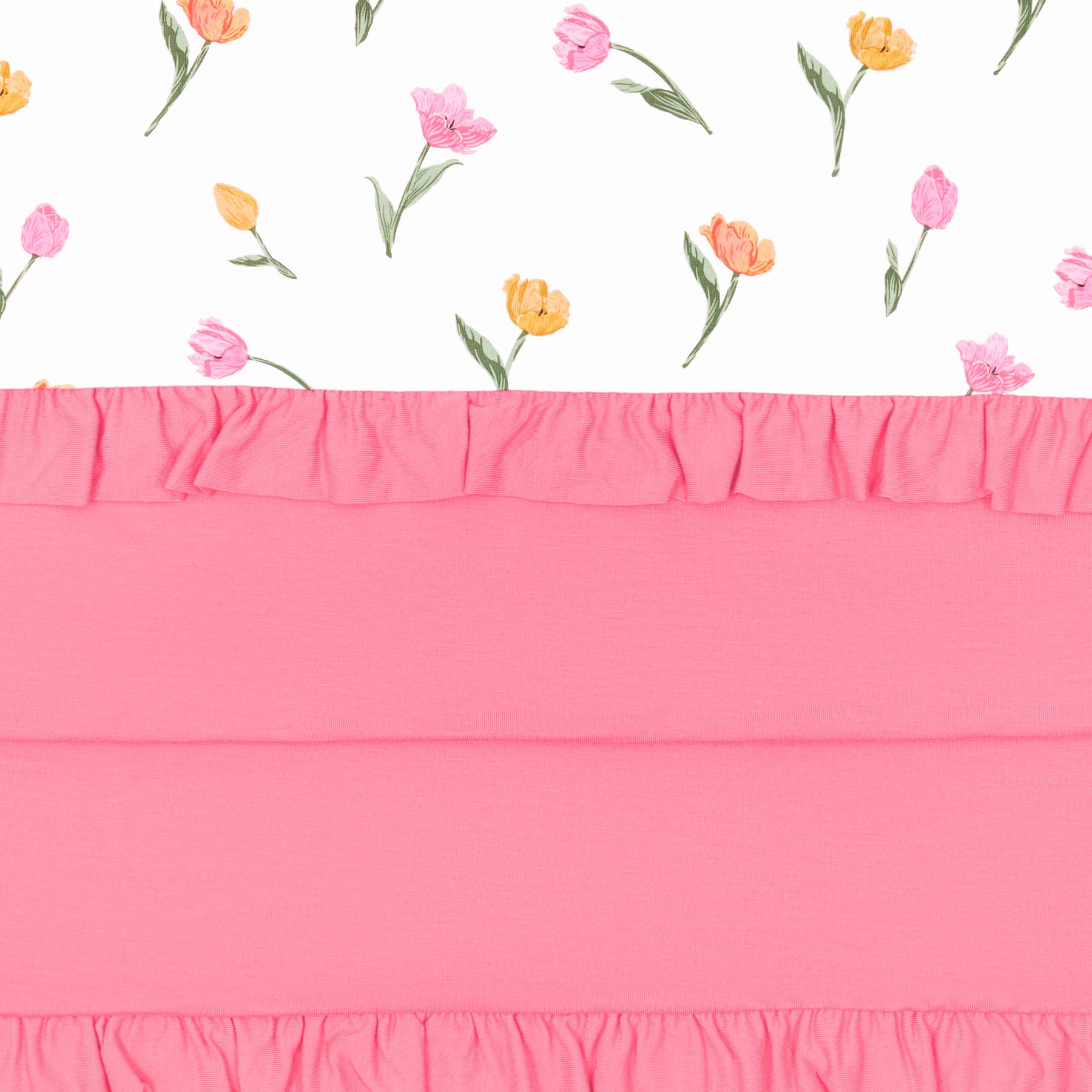 Close up of the Ruffle Baby Blanket in Tulip 0.5 showing the pink backing and floral print top layer