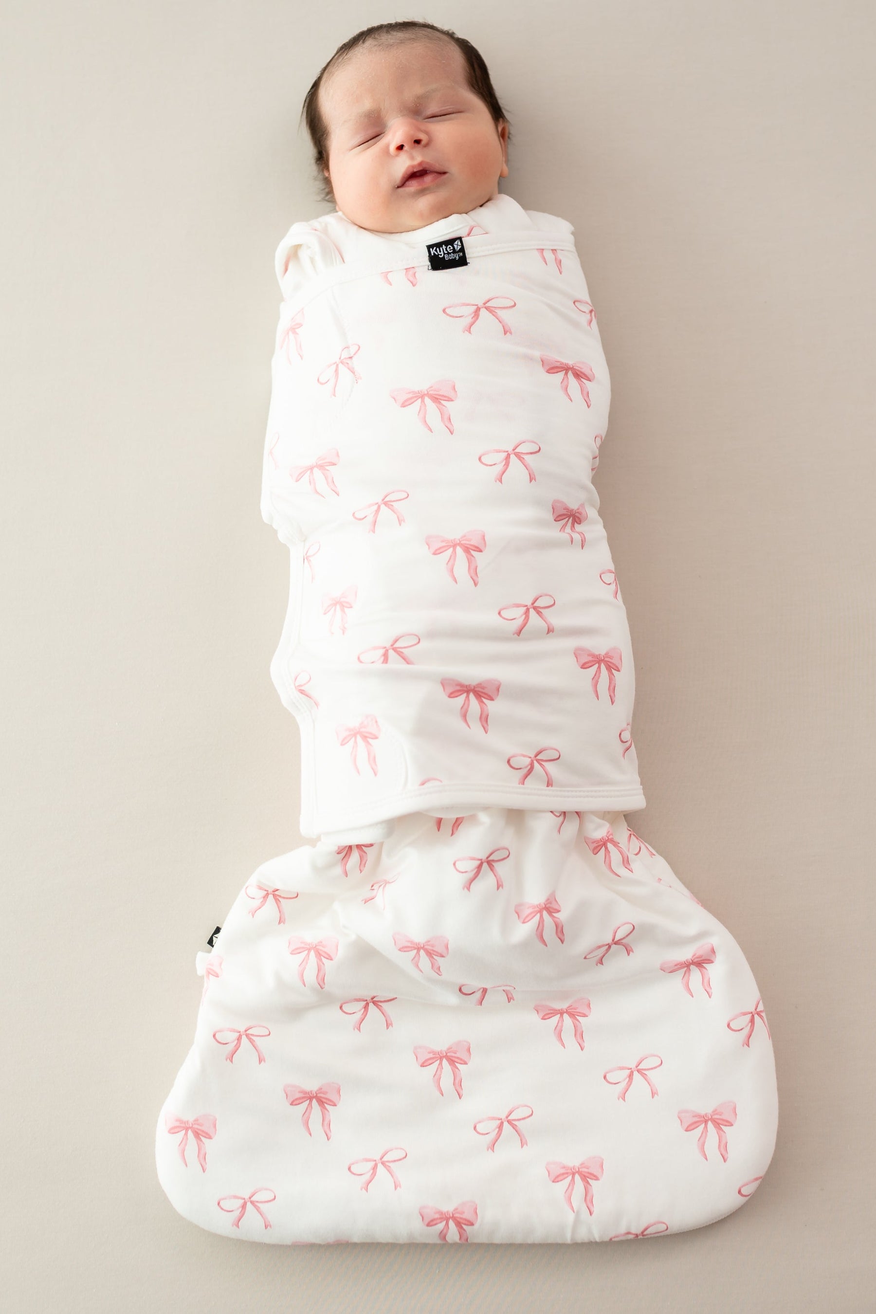 Baby asleep wearing Sleep Bag Swaddler in Bow 1.0