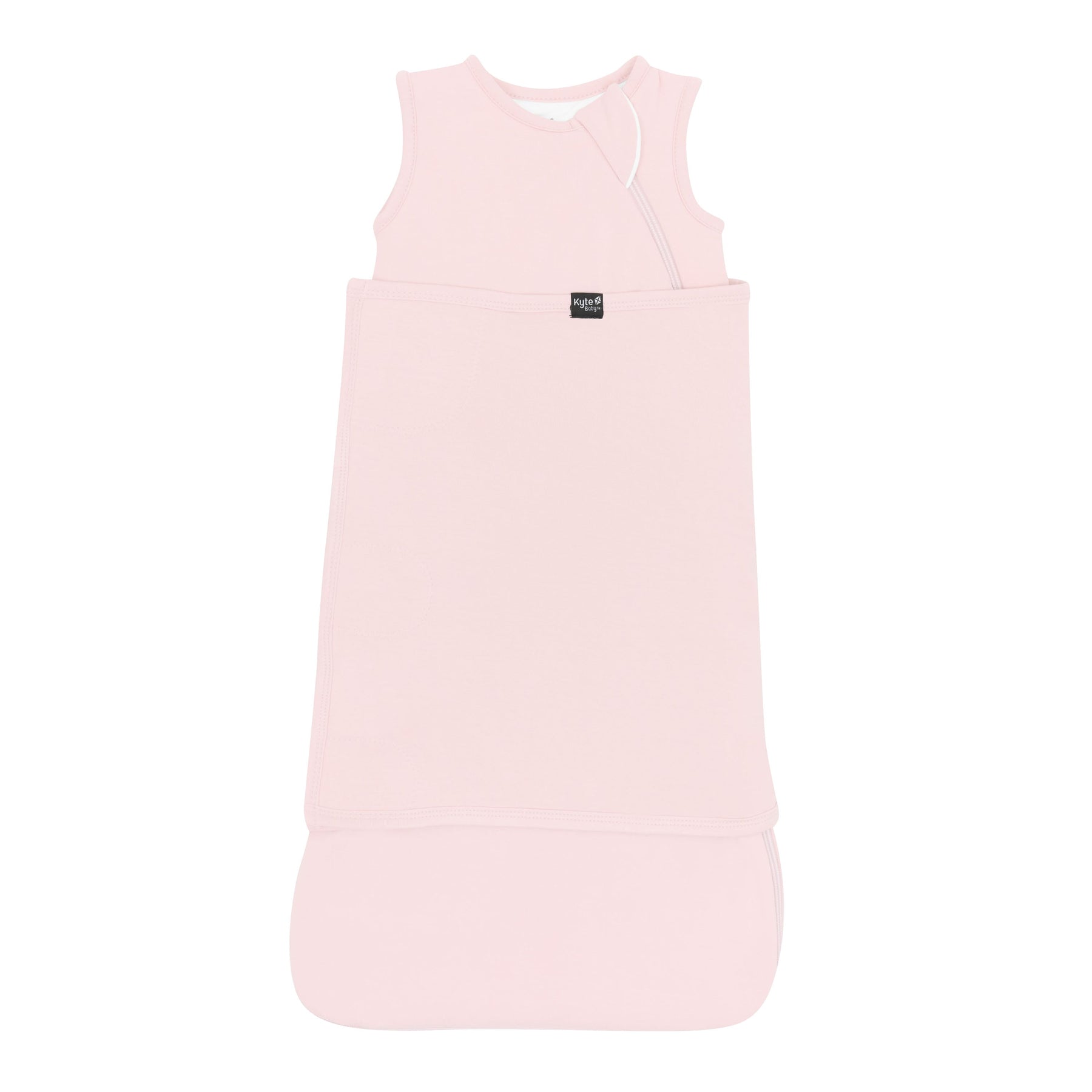 Sleep Bag Swaddler in Blush 1.0 shown swaddled with the Black Kyte Baby logo visible