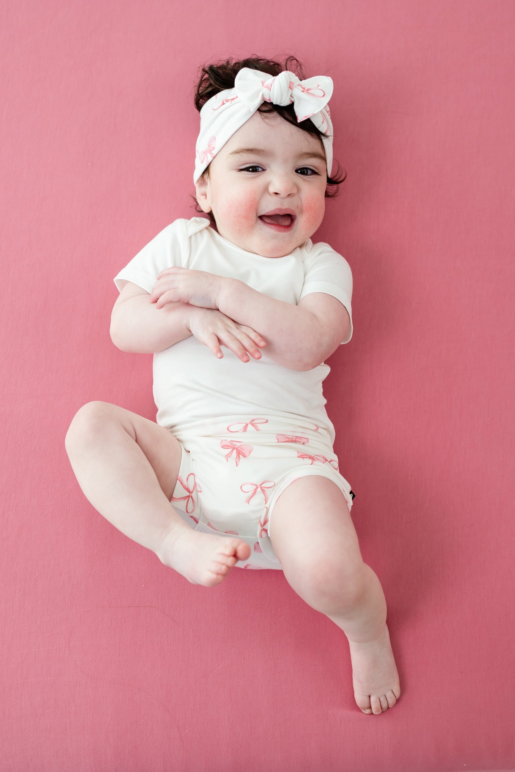 Young toddler modeling Bummies in Bow with matching bow and short sleeve cloud bodysuit