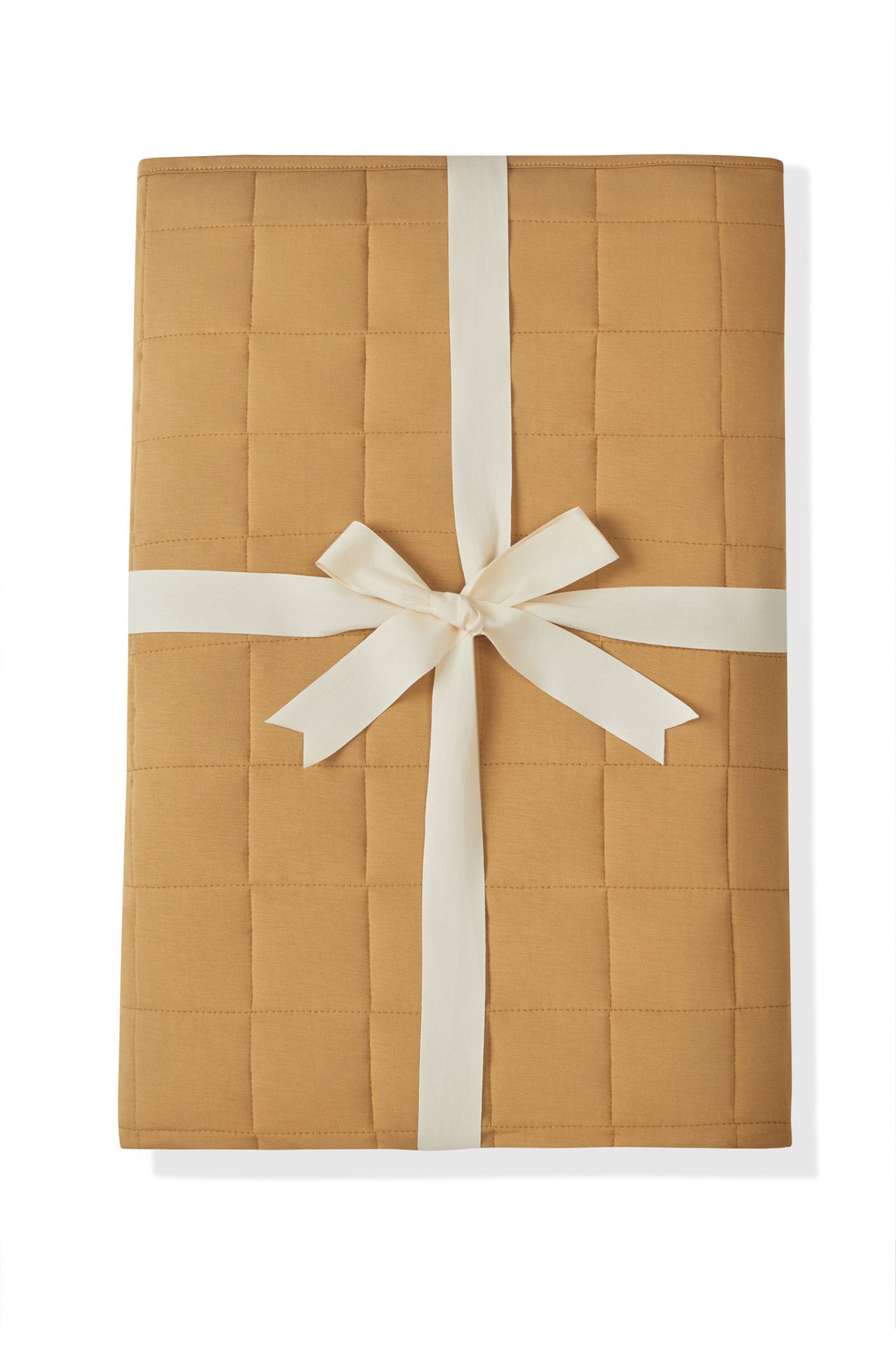 Adult Quilted Blanket in Ochre 2.5 packed with a ribbon on a white background