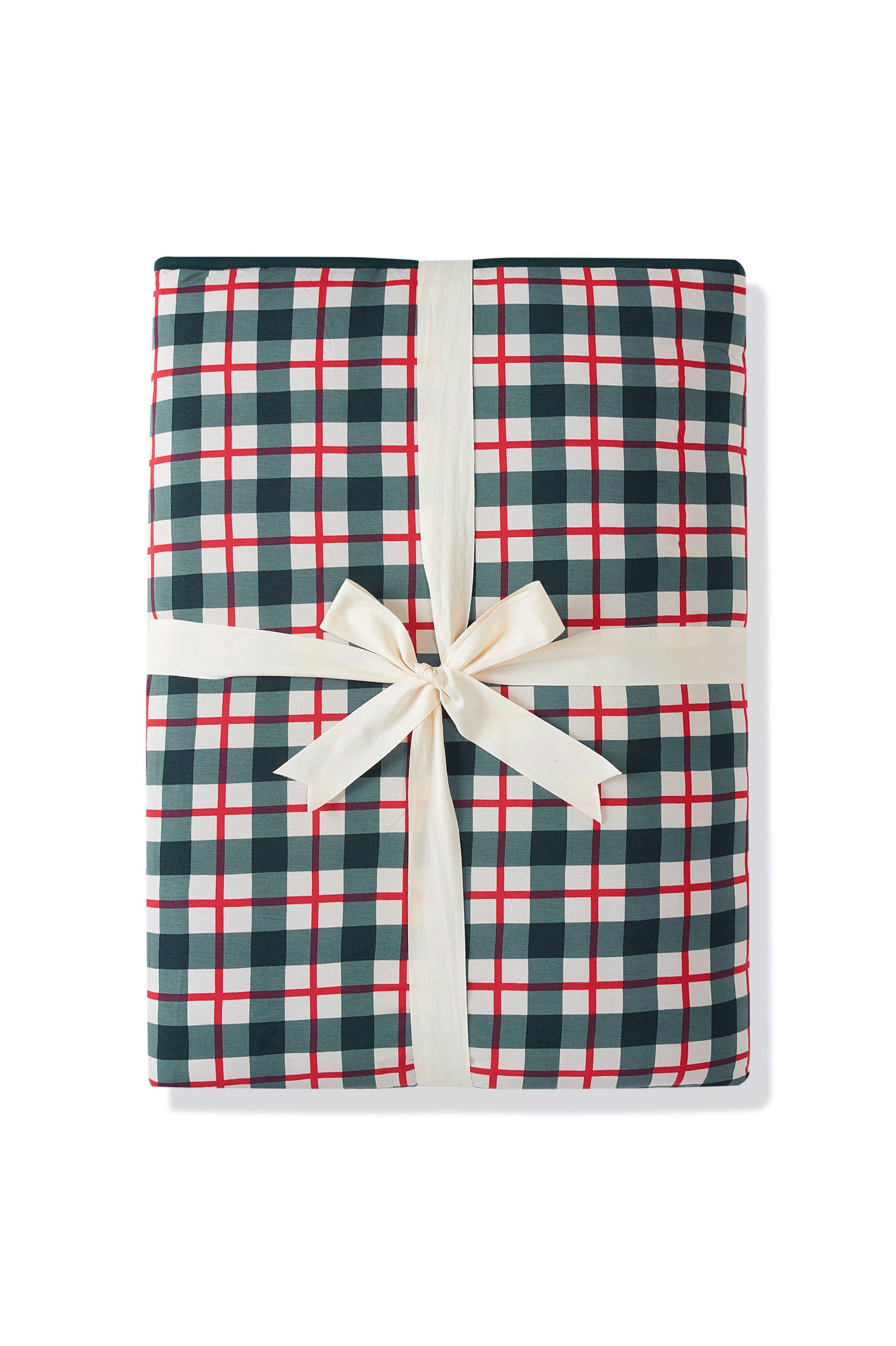 A folded gift box or package wrapped in a green, white, and red gingham plaid pattern, tied with a cream-colored satin ribbon and bow, on a white background.