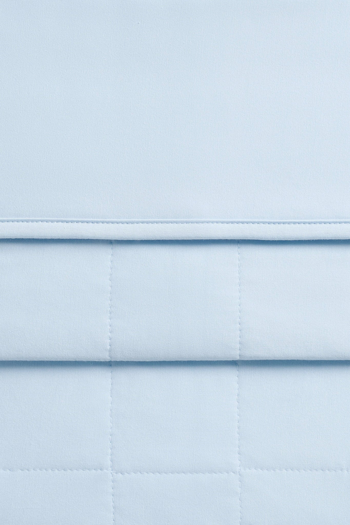 Close up of the Adult Quilted Blanket in Breeze 2.5 showing the quilted backing and smooth top