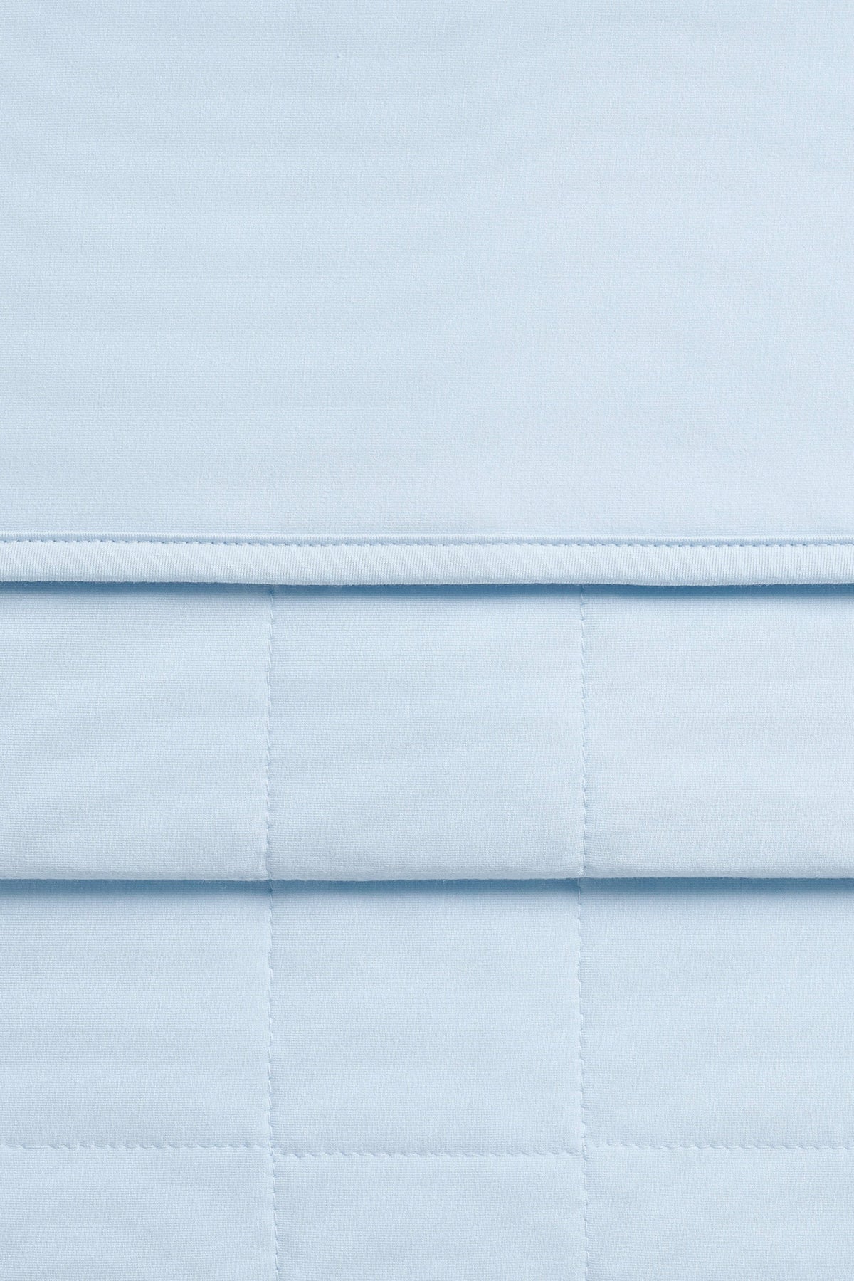 Close up of the Adult Quilted Blanket in Breeze 2.5 showing the quilted backing and smooth top