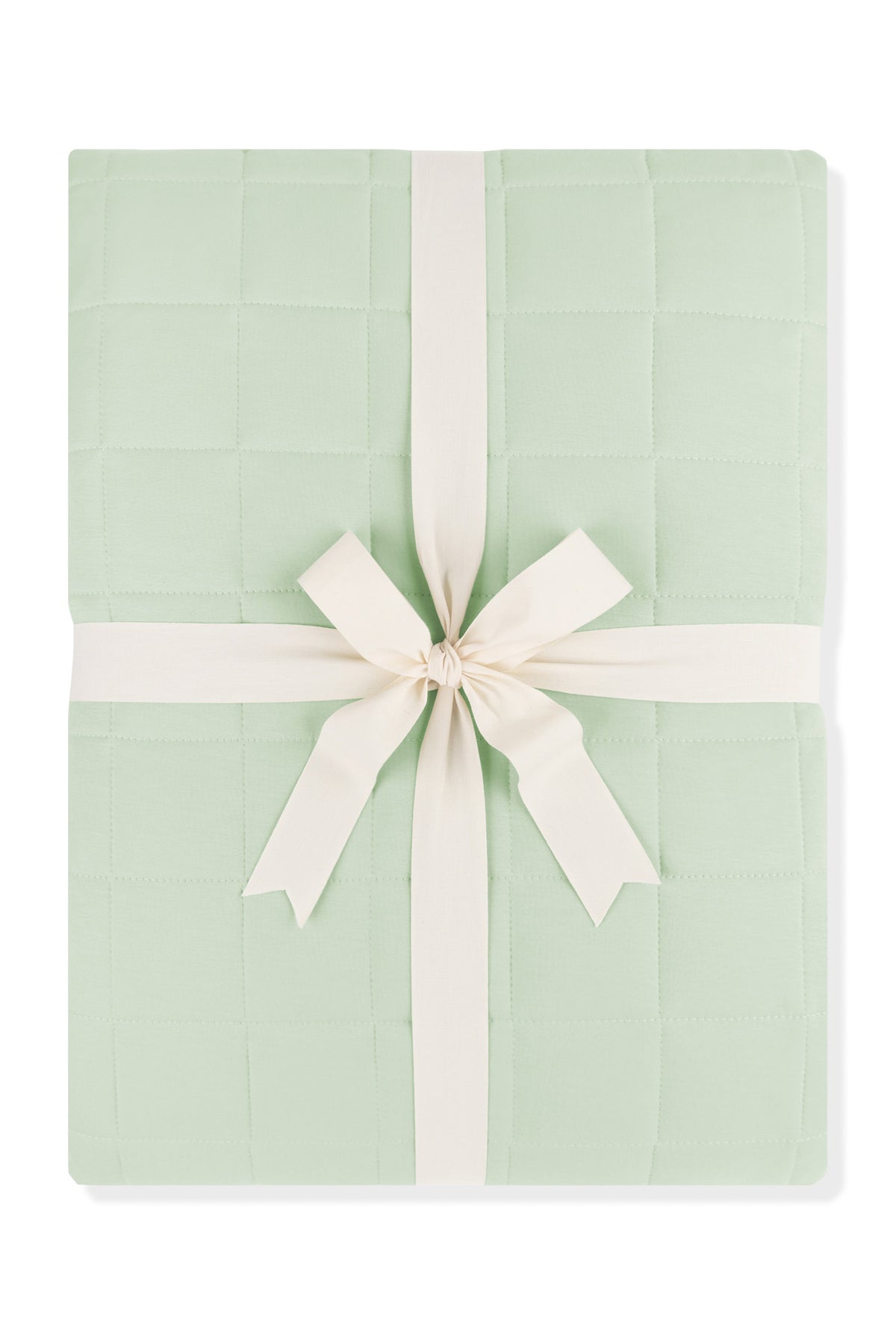 Adult Quilted Blanket in Basil 1.0 shown in its packaging tied with a linen bow