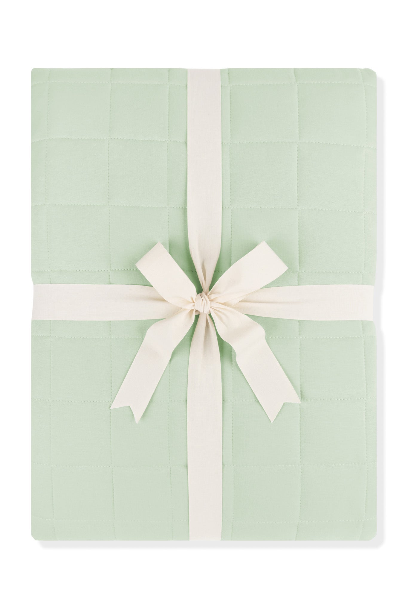 Adult Quilted Blanket in Basil 1.0 shown in its packaging tied with a linen bow
