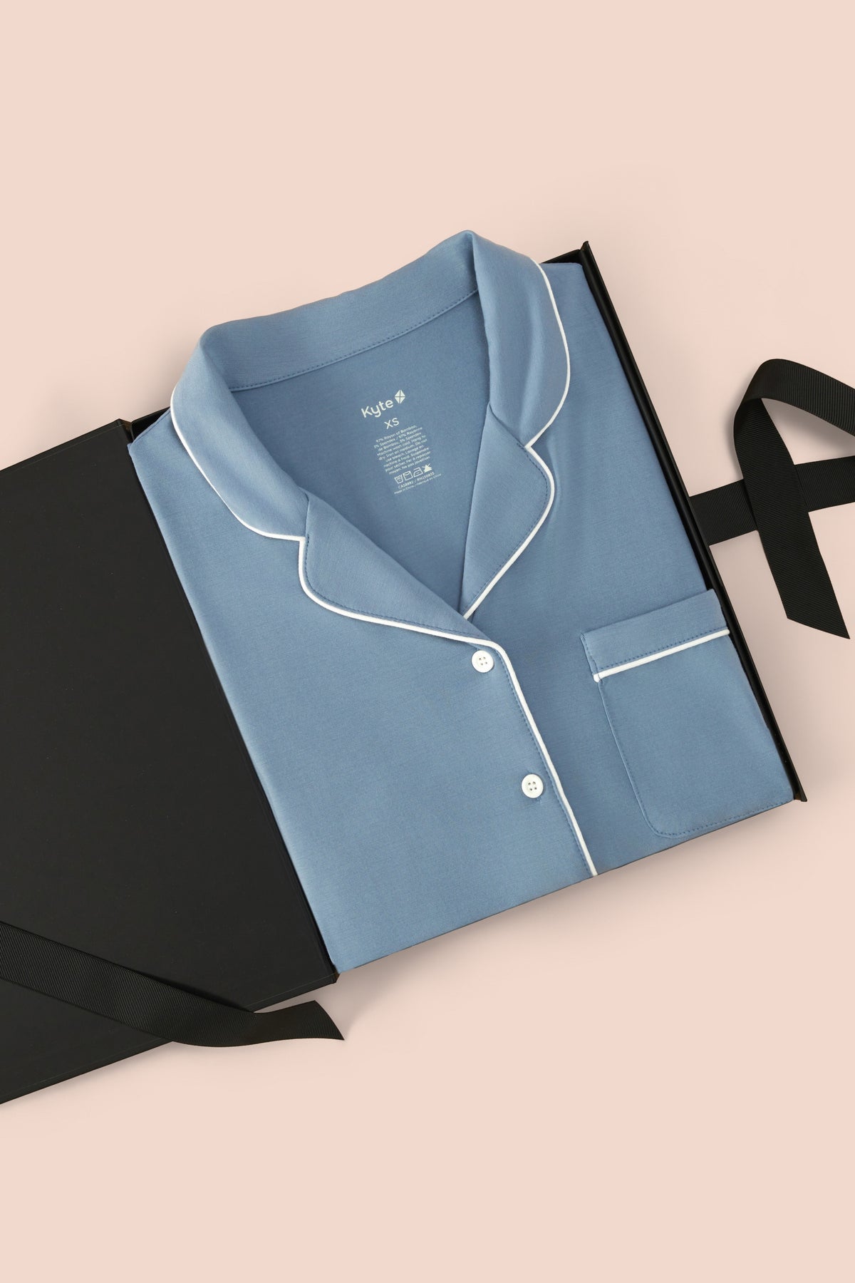 Long-Sleeved Women's Pajama Set in Slate with Cloud Trim packed in a box on a beige background