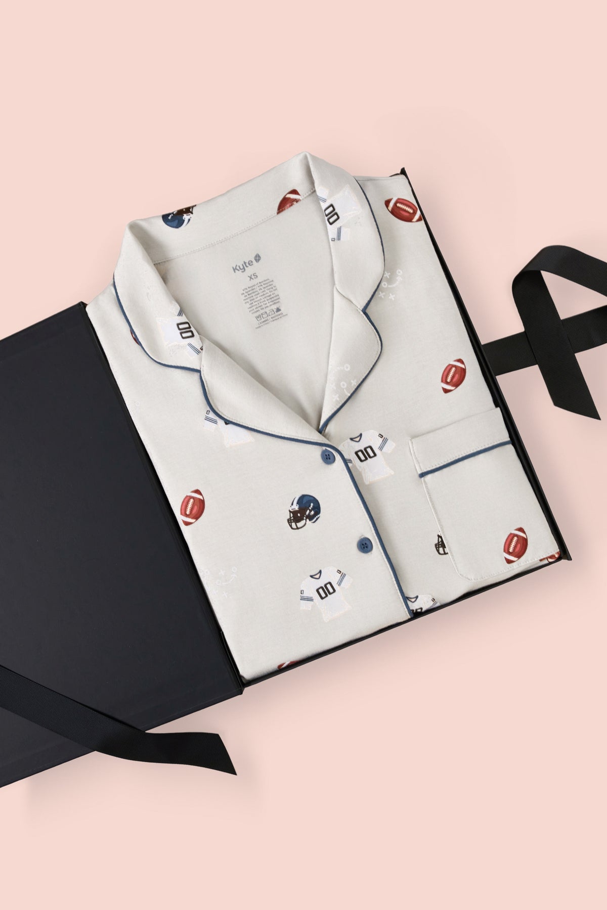 Long-Sleeved Women's Pajama Set in Vintage Football print packed in a box on a white background