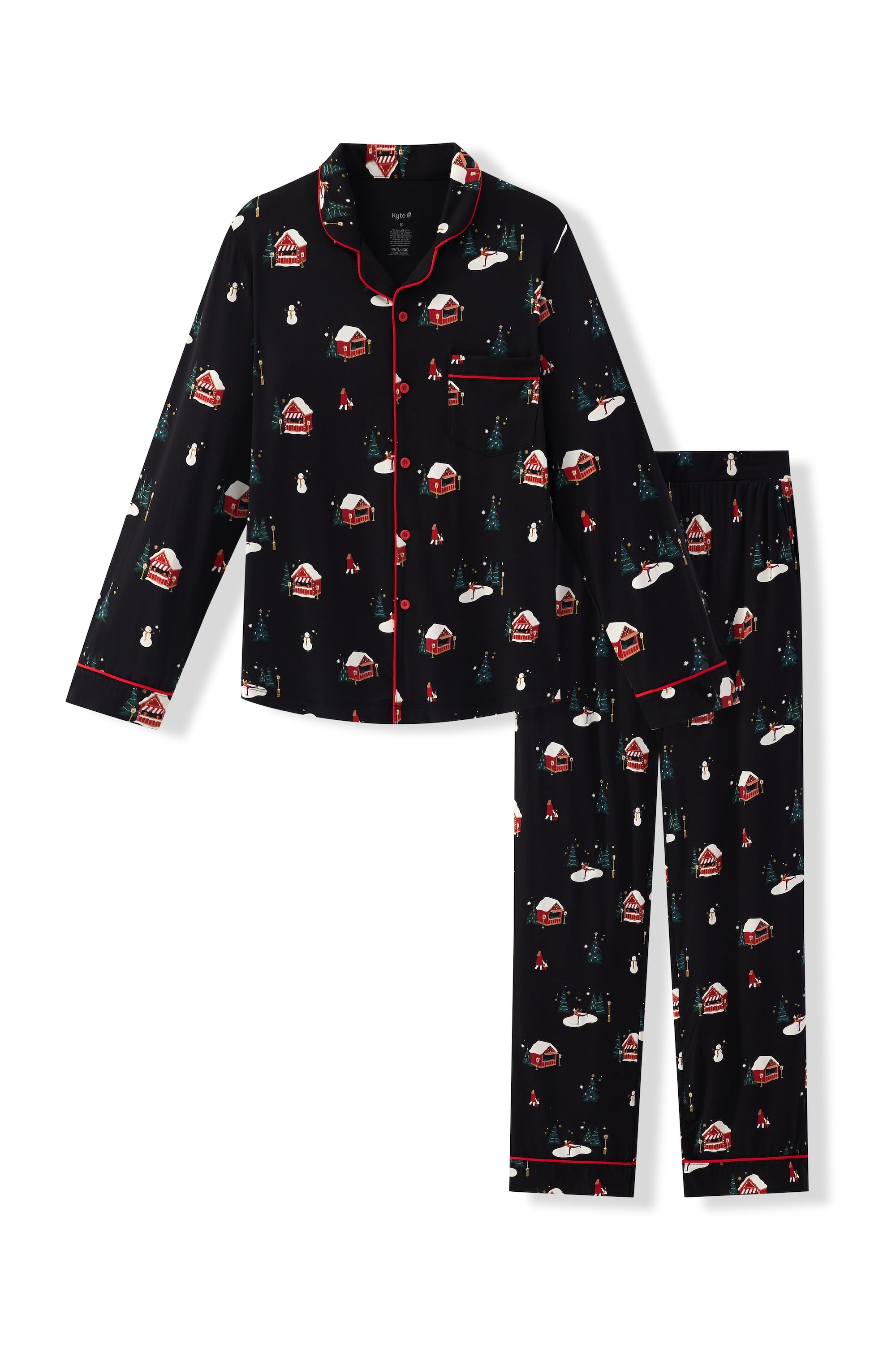 A two-piece men's pajama set featuring a long-sleeve button-front top and matching pants in black with a festive holiday print of green Christmas trees, red and white hut, and white snowman, accented with red piping.