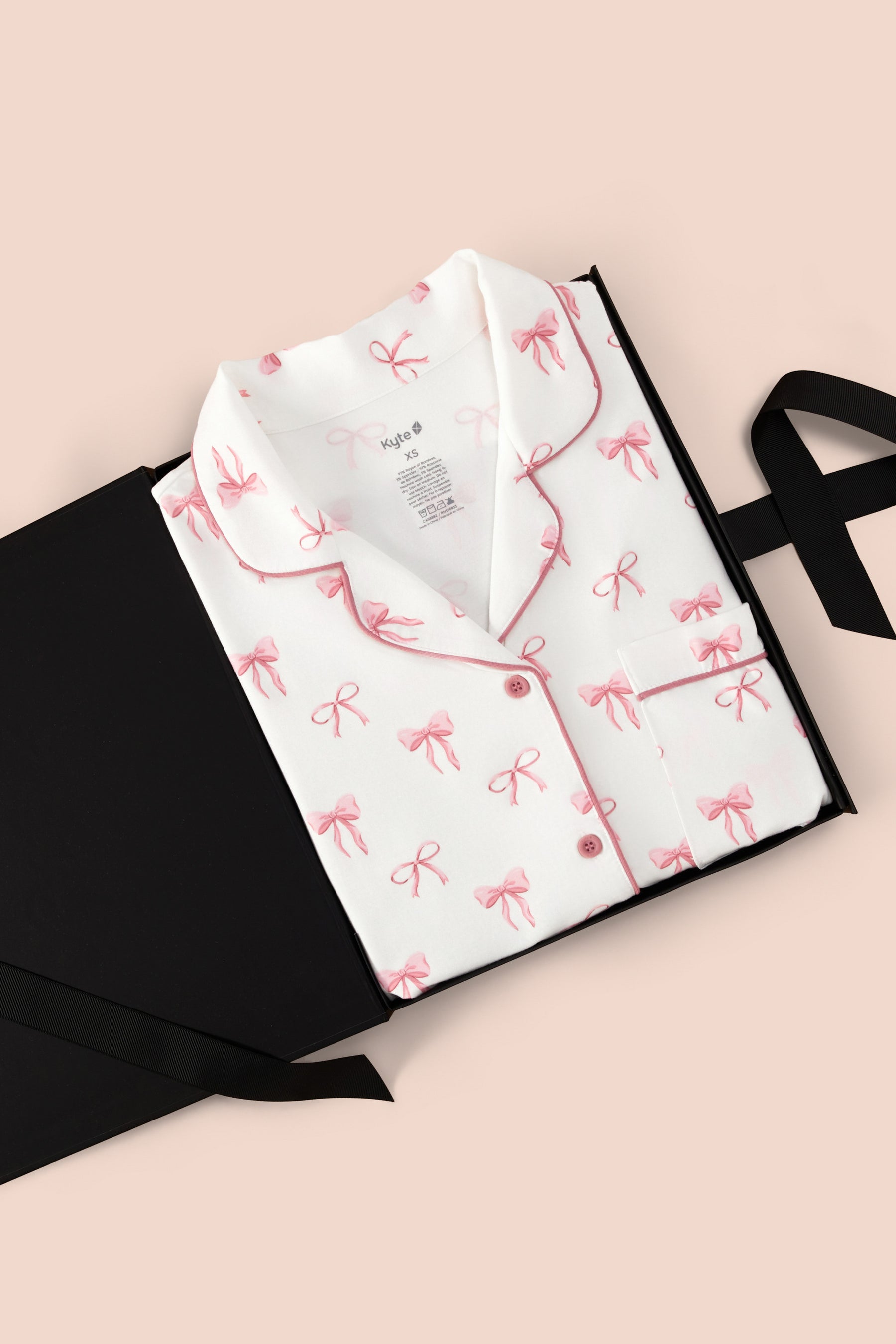 Women’s Short Sleeve Pajama Set in Bow print packed in a box on a beige background