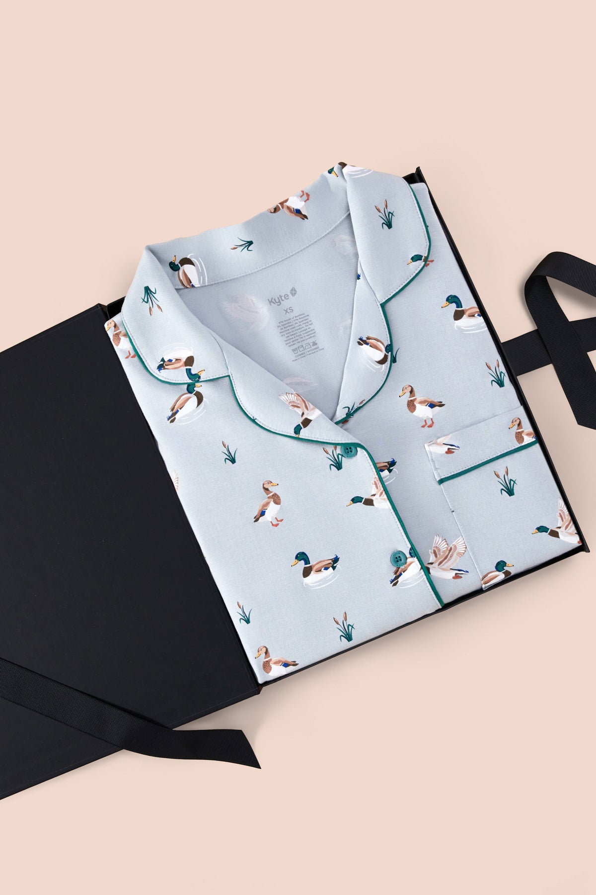 Long-Sleeved Women's Pajama Set in Mallard Duck print packed in a box on a beige background