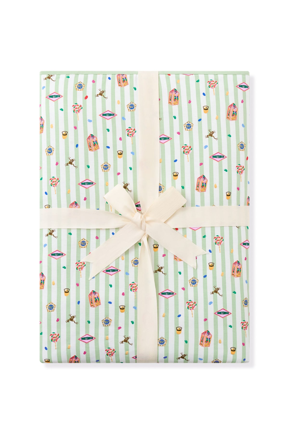 Packed green and white striped youth blanket with colorful Harry Potter pattern print with a ribbon a a white background