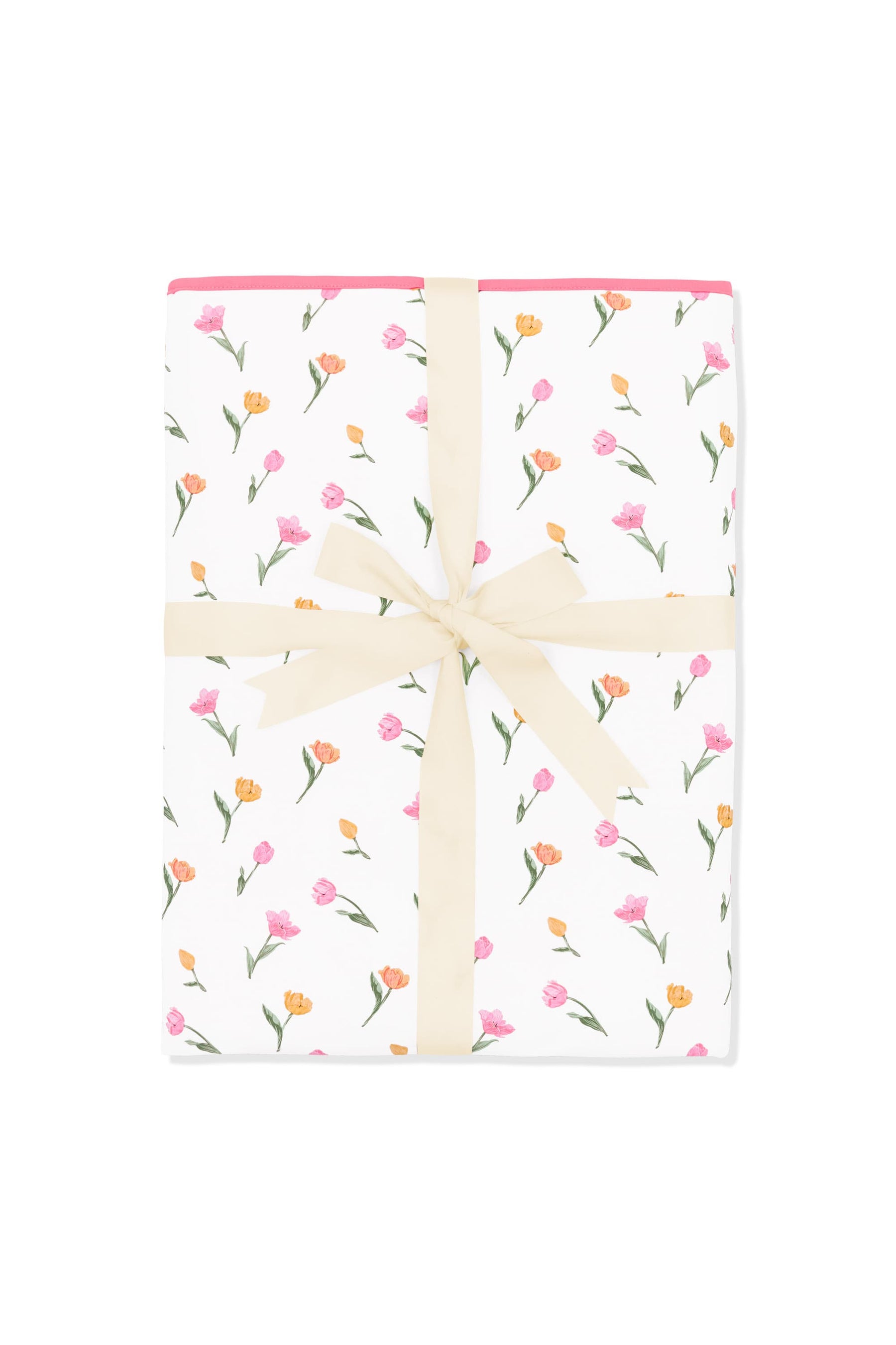 Youth Blanket in Tulip 1.0 shown in its packaging tied with a linen bow
