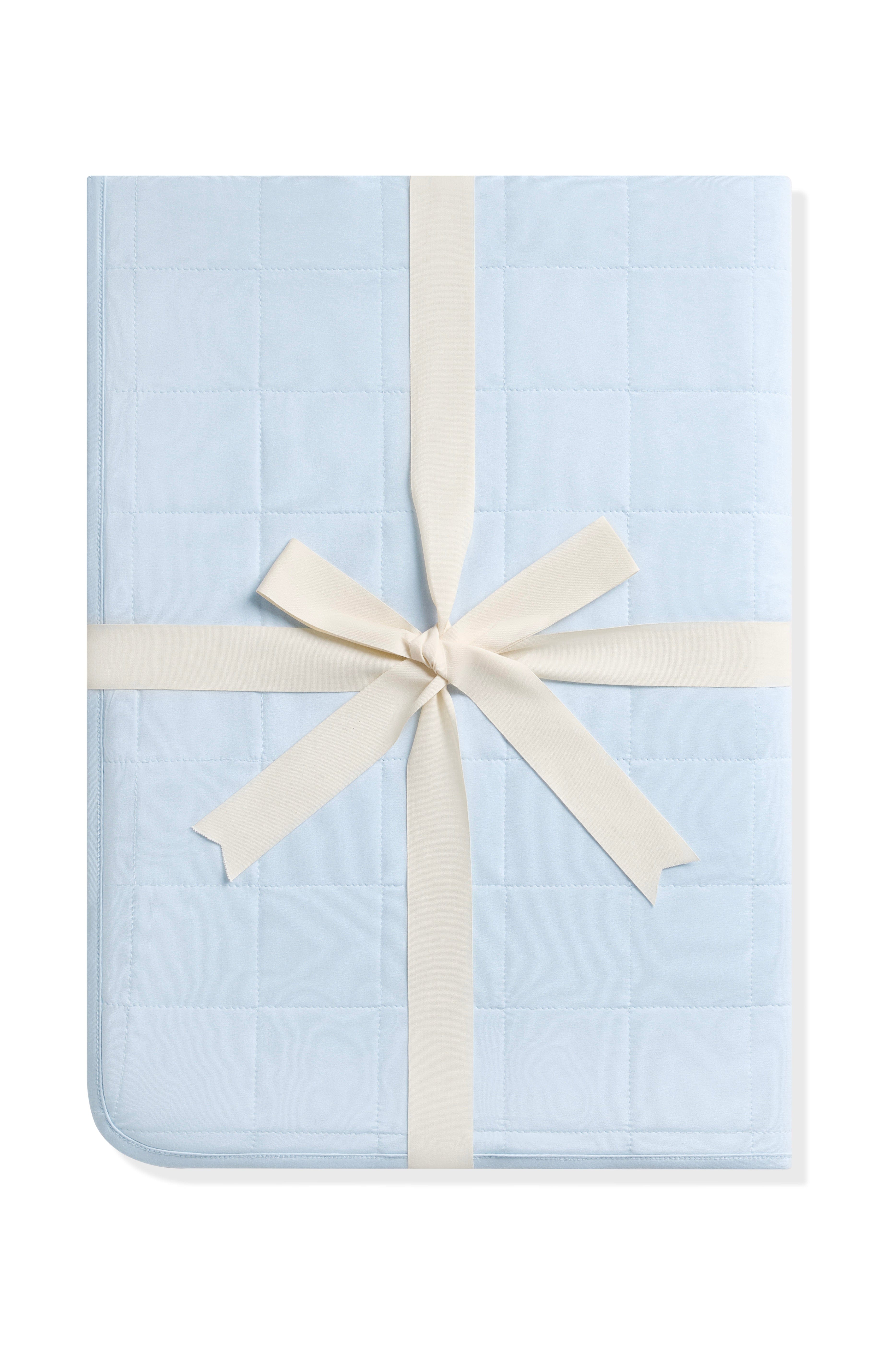 Youth Blanket in Breeze 1.0 shown in its packaging tied with a linen bow