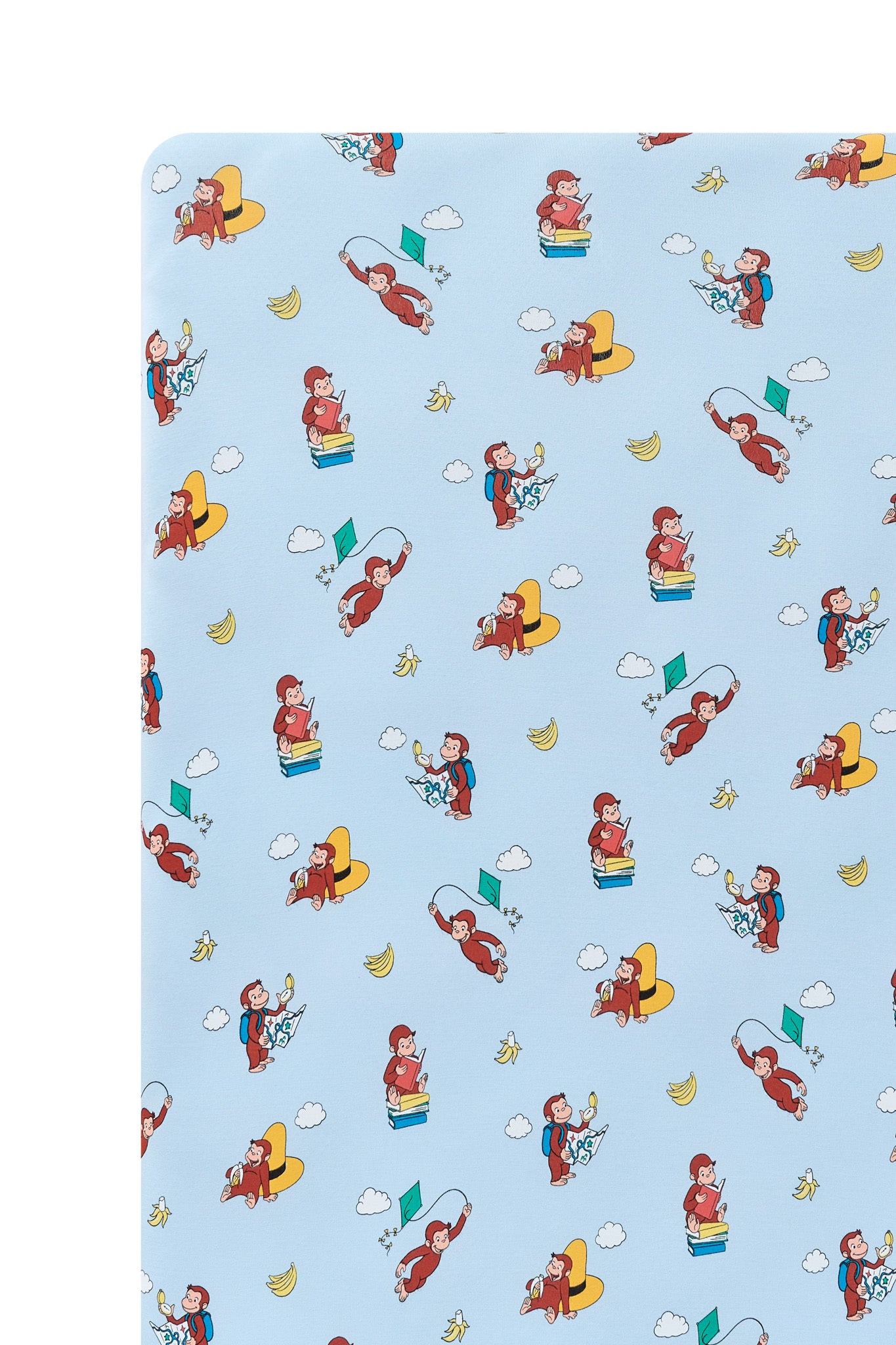 Close up of Blue Crib Sheet in Curious George print on a white background