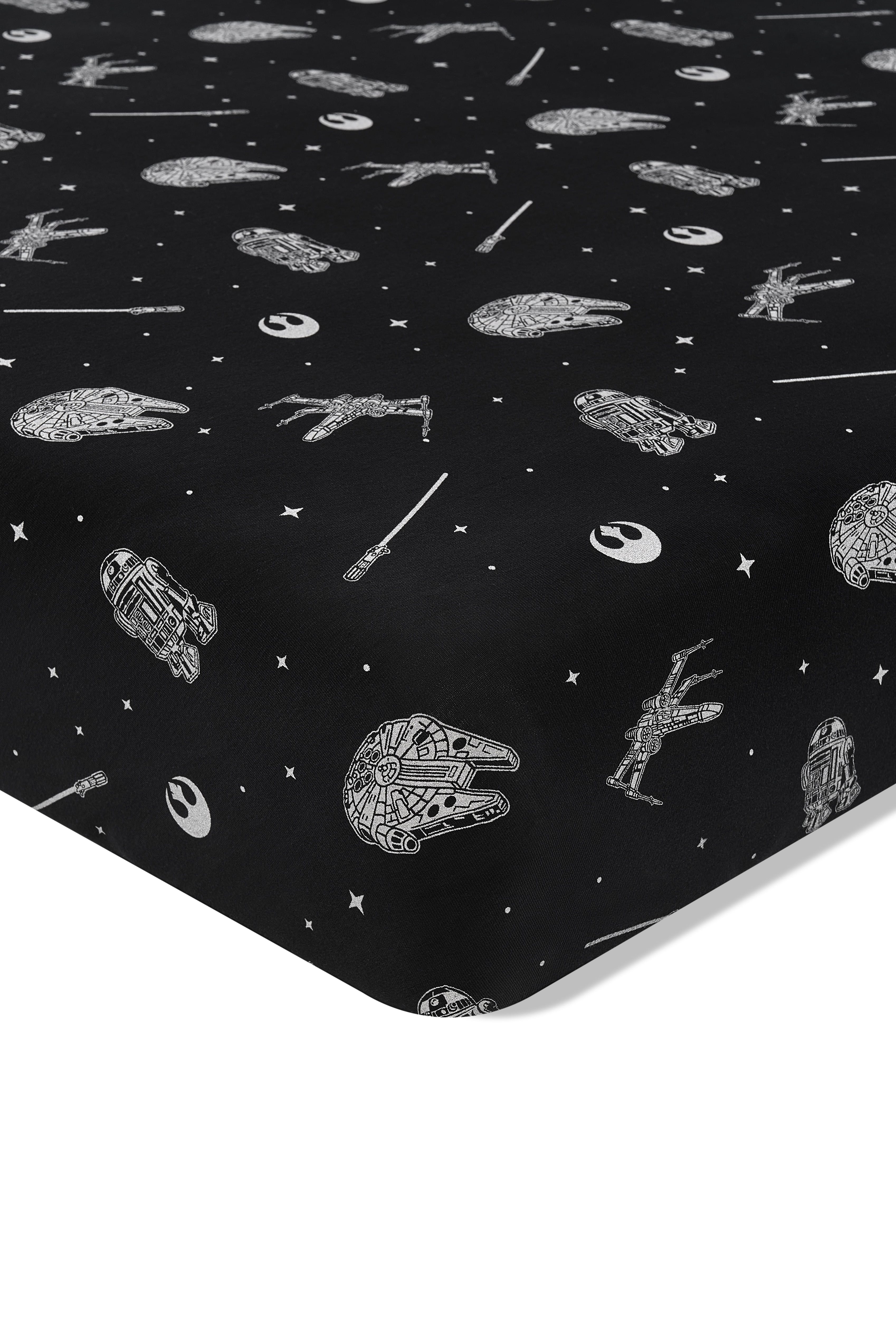 Close up of the corner of the Crib Sheet in STAR WARS™ on a crib mattress