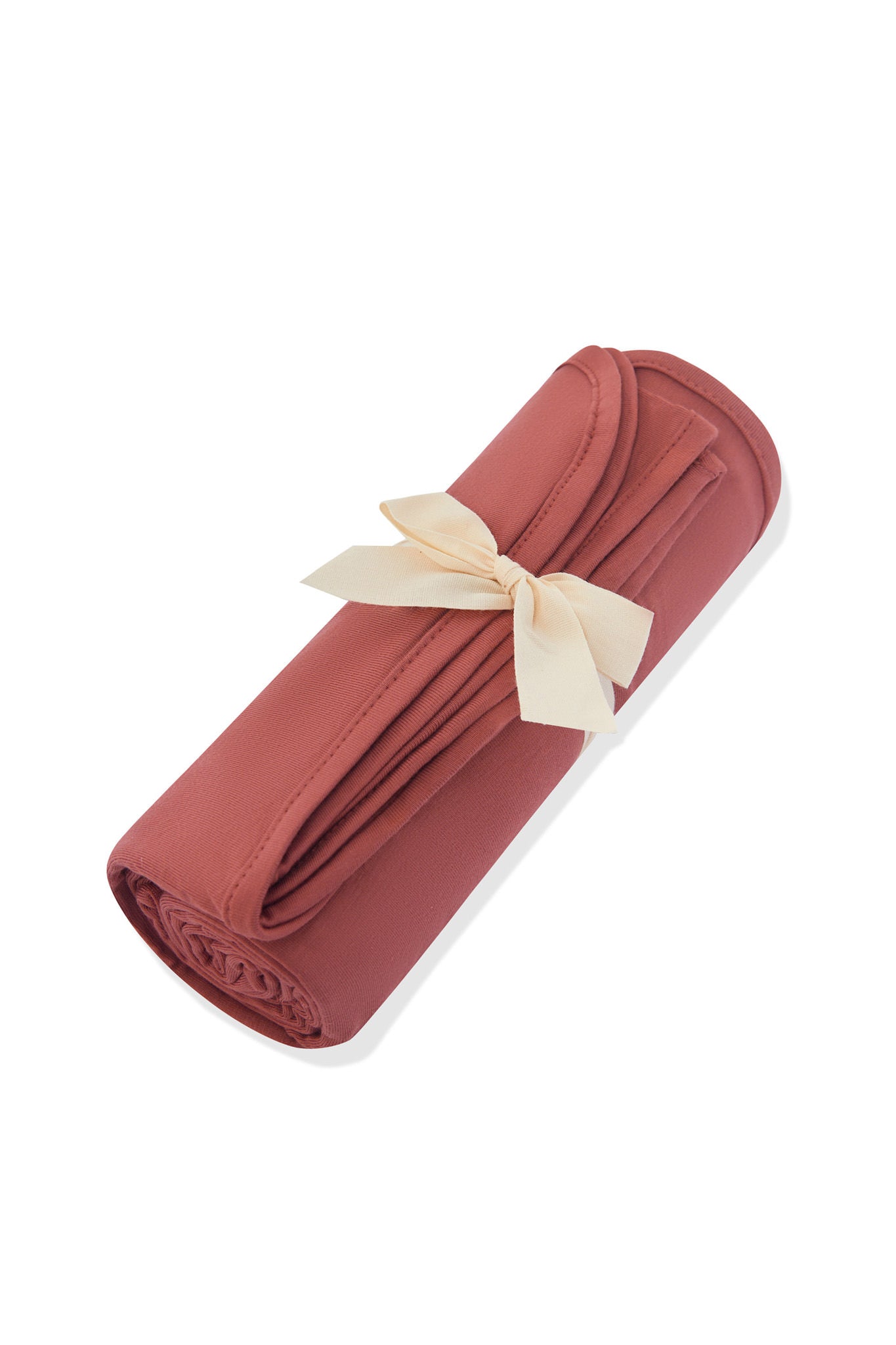 Swaddle Blanket in Ember rolled and tied with a ribbon on a white background