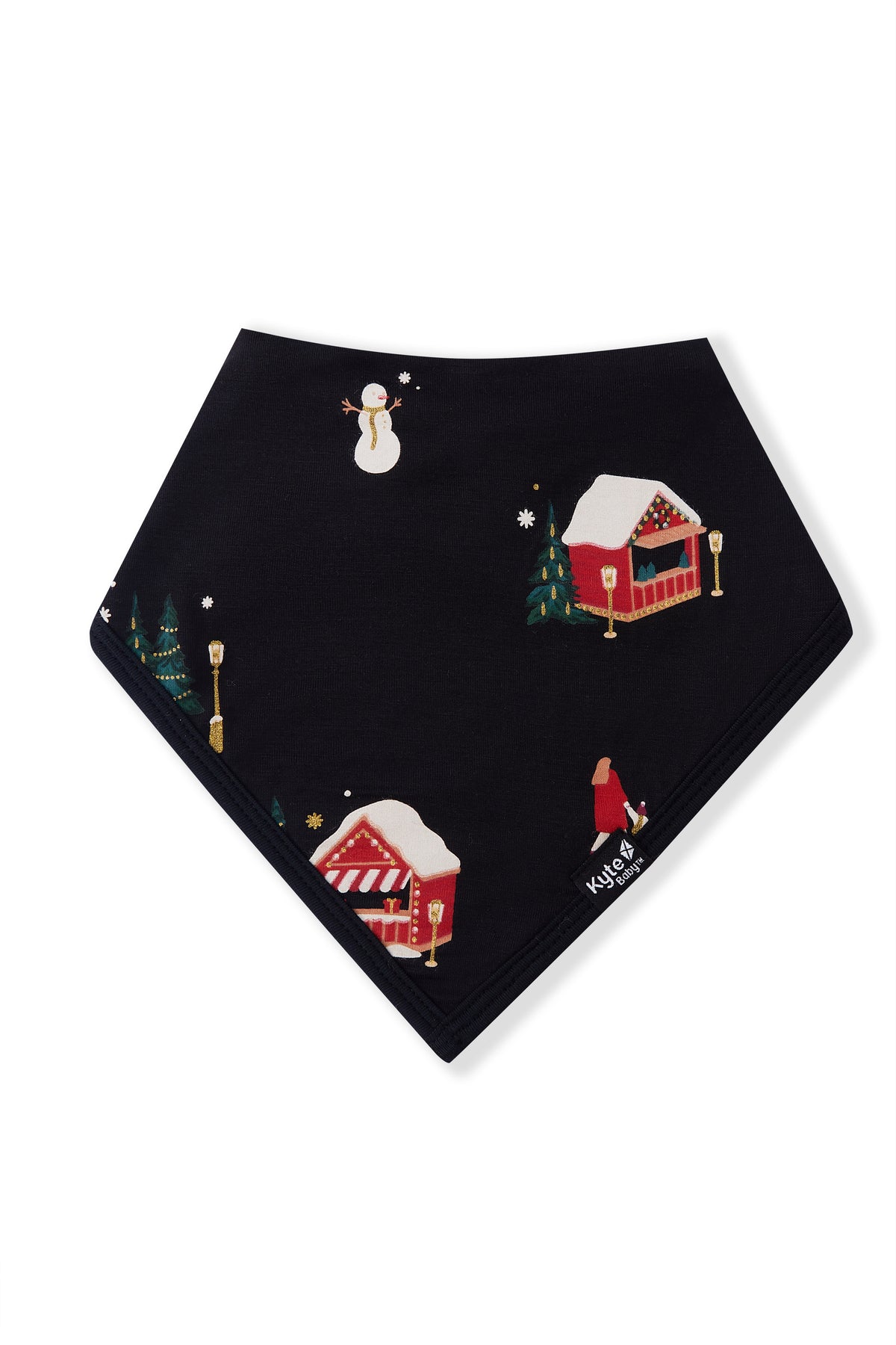 A black triangular bandana bib featuring a festive Christmas village print with snowman, market stalls, trees, and a child, displayed flat against a white background.