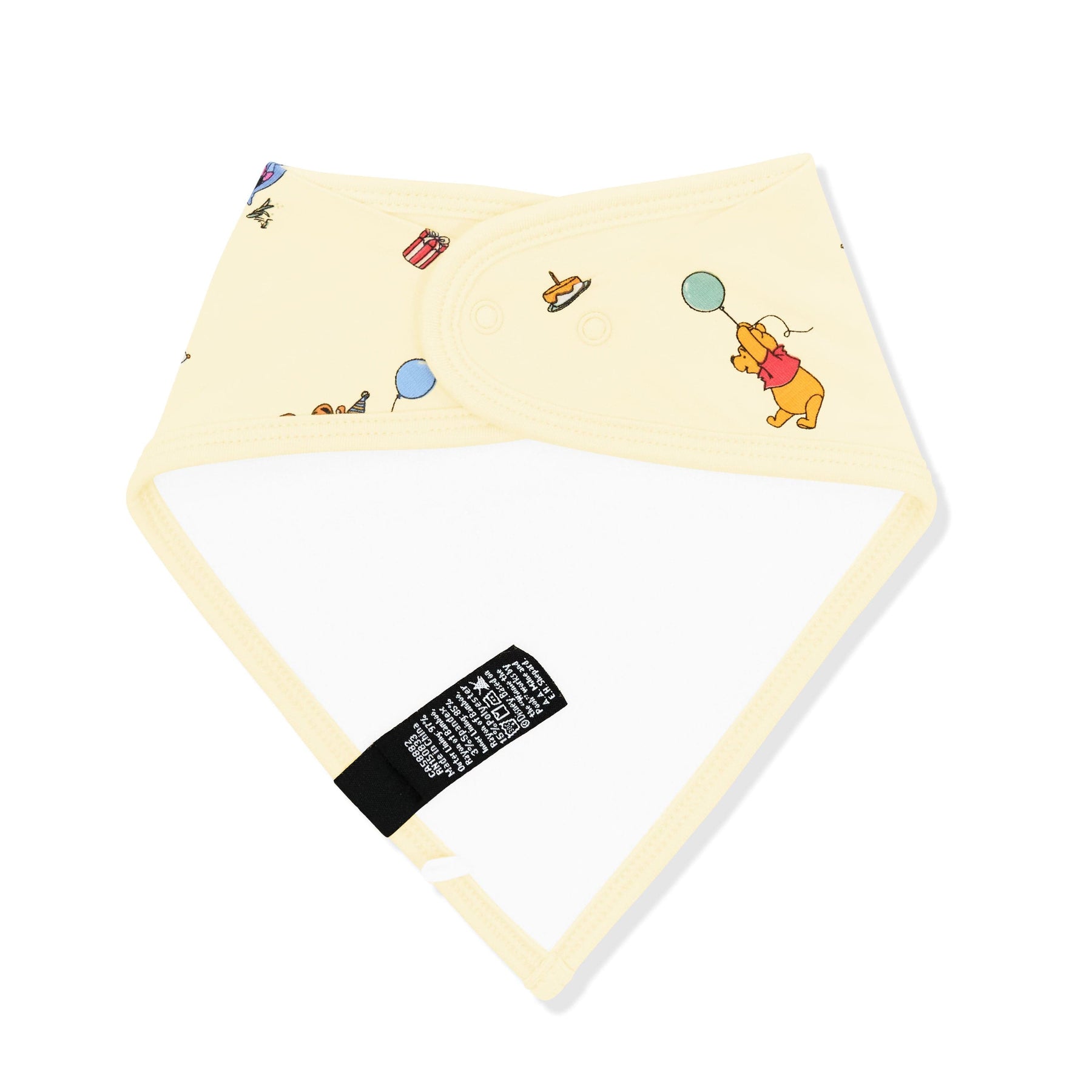 The back of the Bib in Winnie the Pooh Celebration showing the snap closure and bamboo terry cloth backing