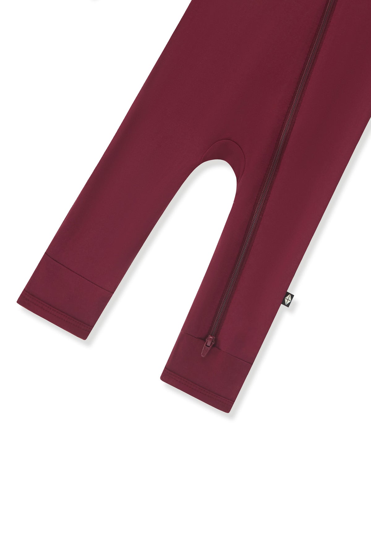 Bottom zipper shown on the leg of the Zippered Romper in Burgundy on a white background