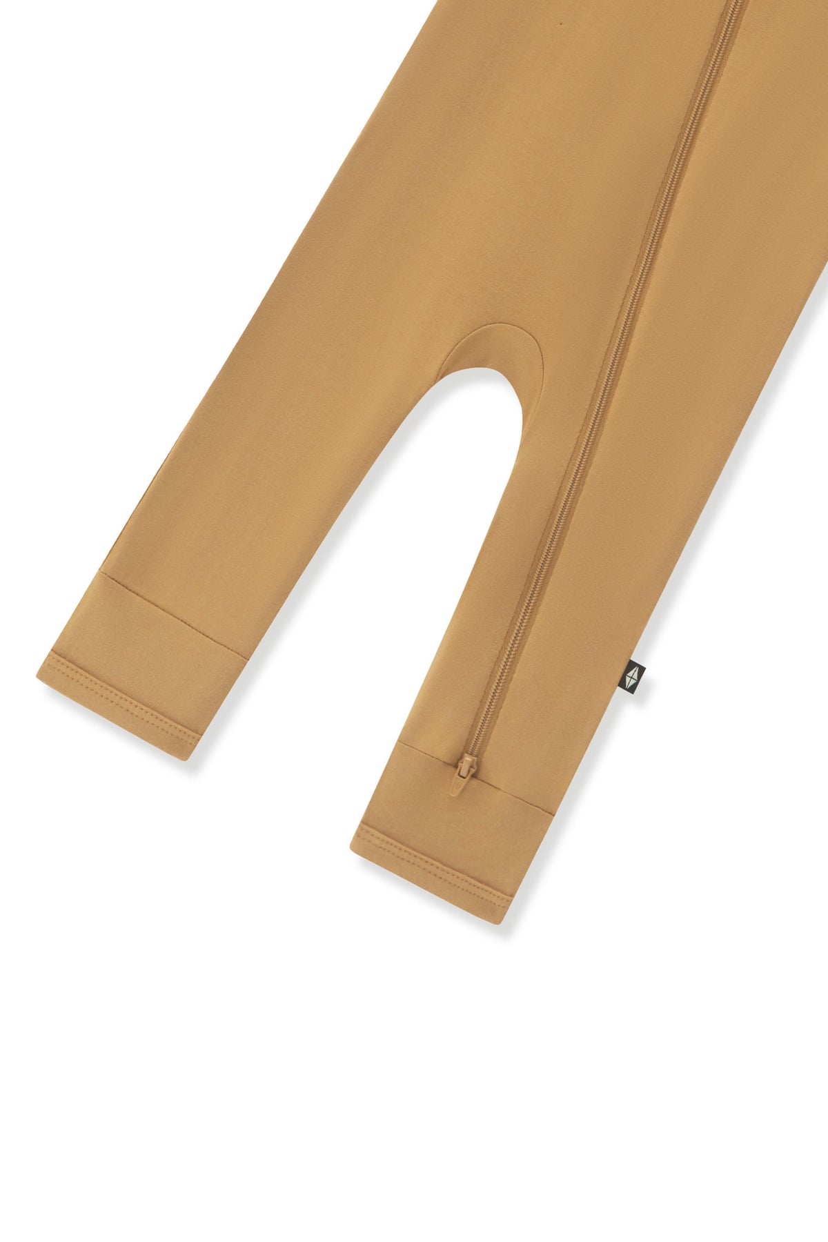 Bottom zipper shown on the leg of the Zippered Romper in Ochre on a white background