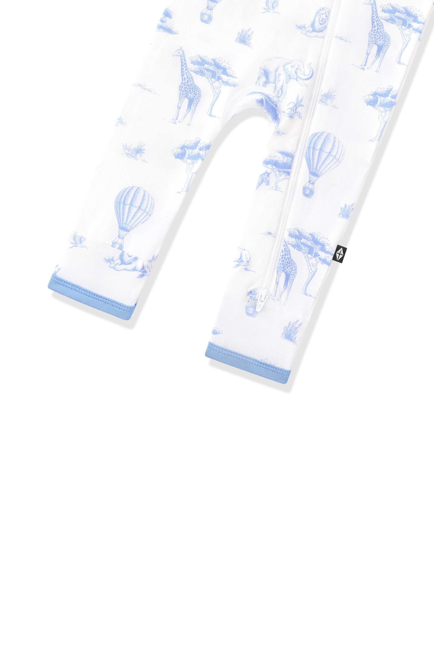 The zipper closure shown on the leg of the Zippered Romper in Toile Safari with the black kyte baby tag visible