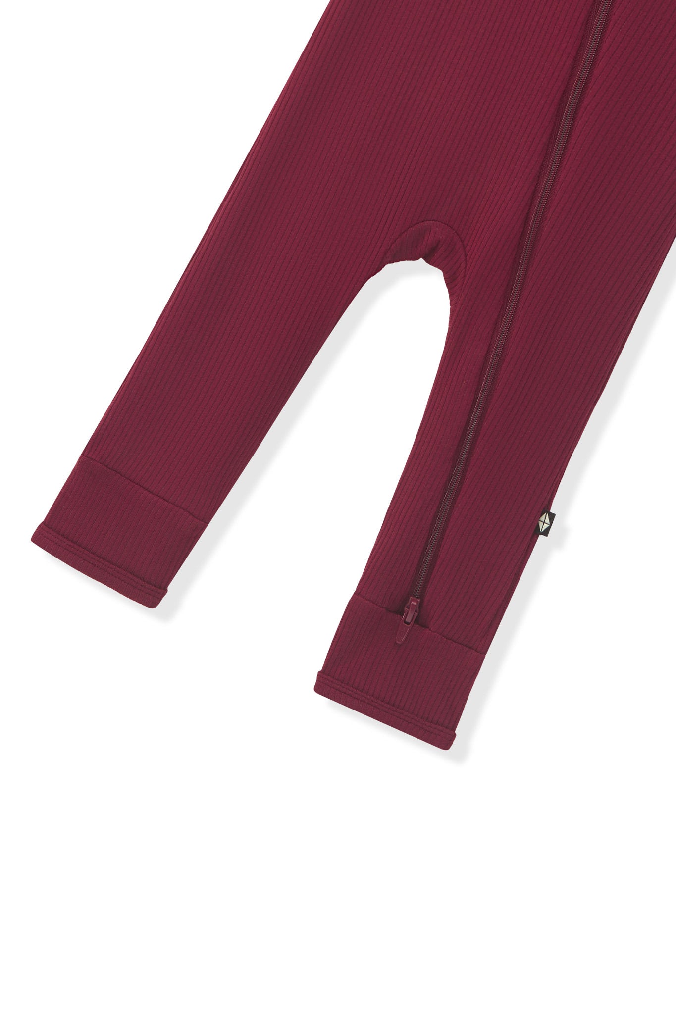 Zipper shown on the leg of the Ribbed Zipper Romper in Burgundy on a white background