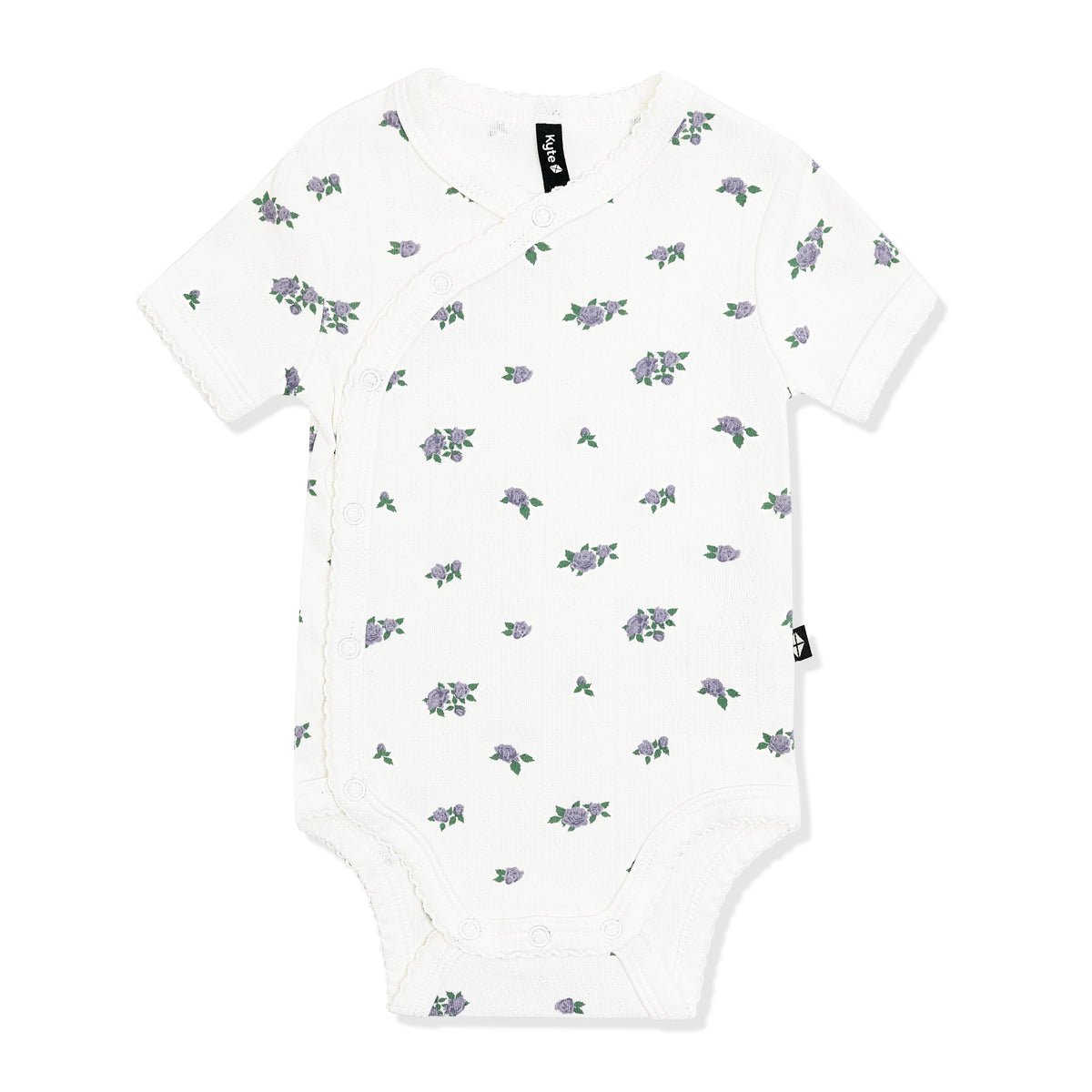 Pointelle Kimono Bodysuit in Spray Rose with the picot trim shown on the white surface